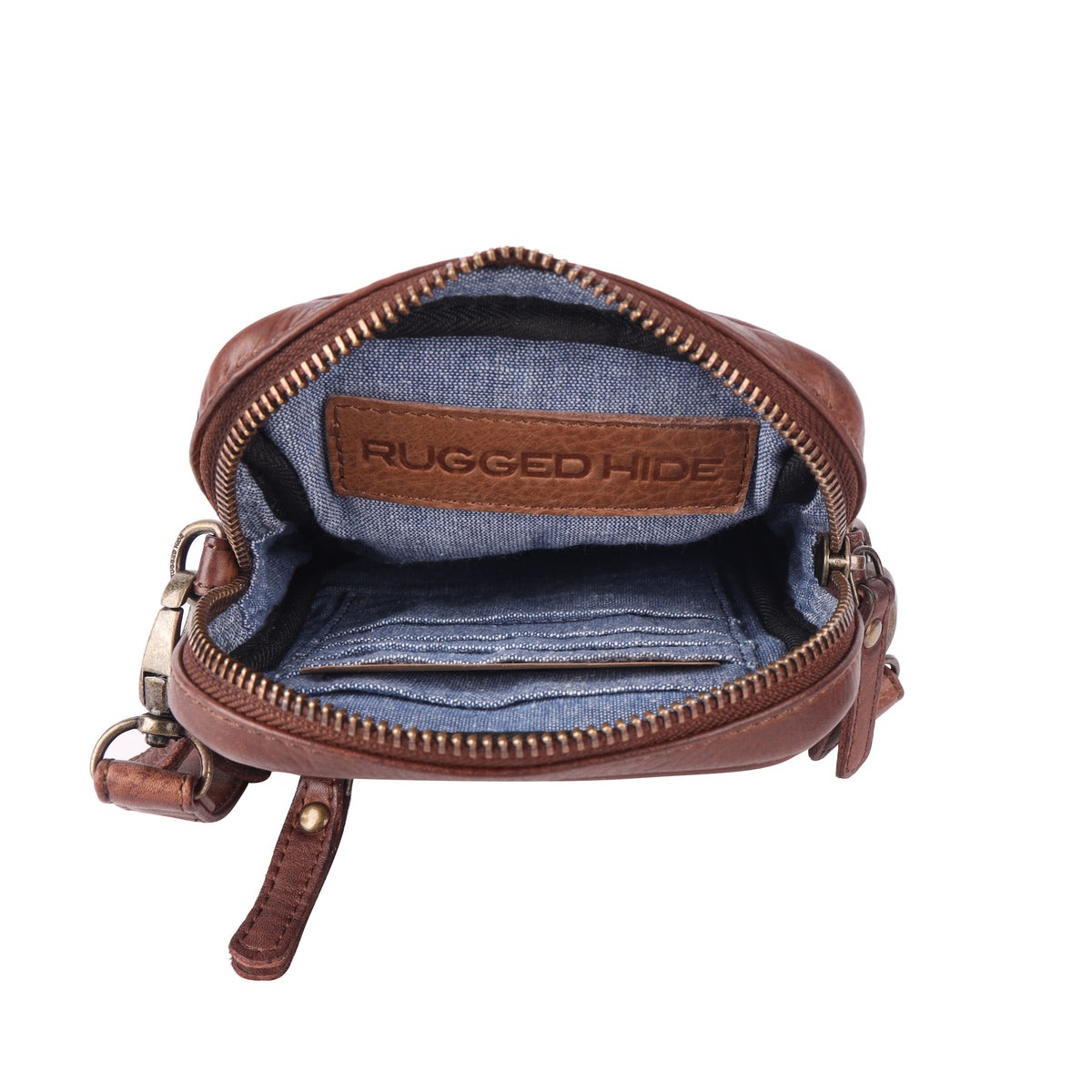 The brown bag unzipped from above, showing the blue fabric lining, card slots and a stamped leather tab