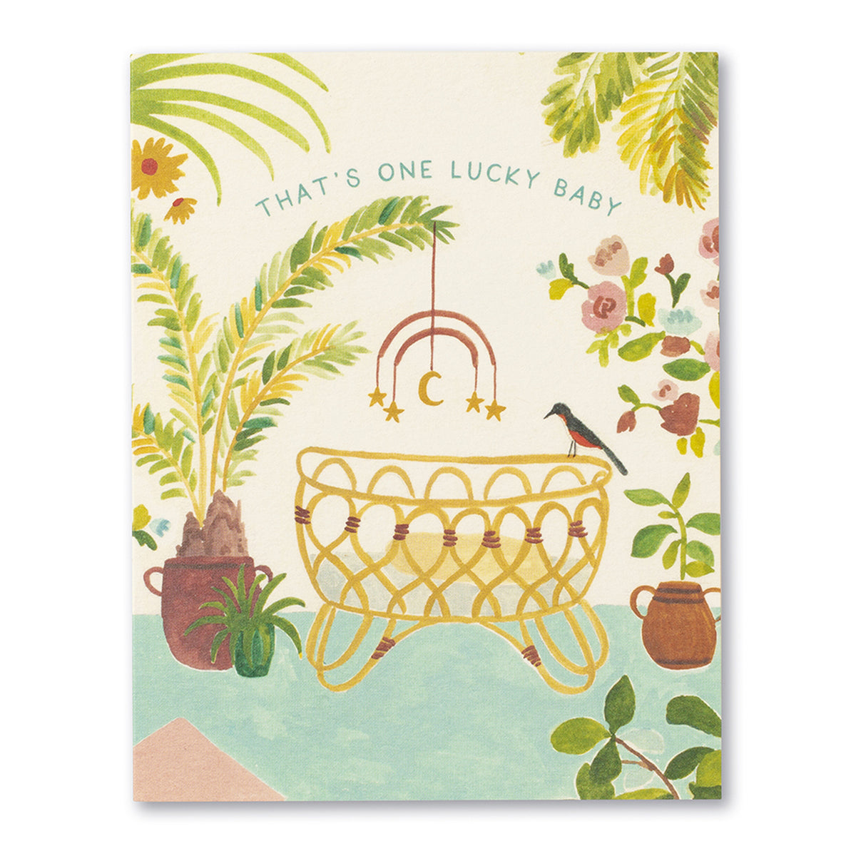 Front of the That's One Lucky Baby card: a rattan bassinet under a moon and star mobile, with potted palms and pink flowers