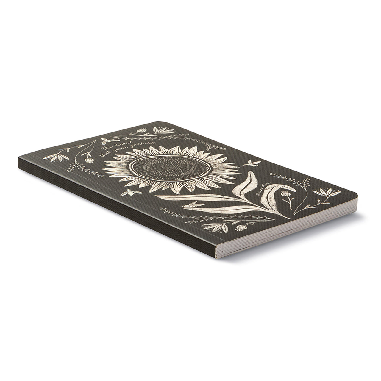 Angled view of the closed black journal showing the white sunflower cover and its page edges