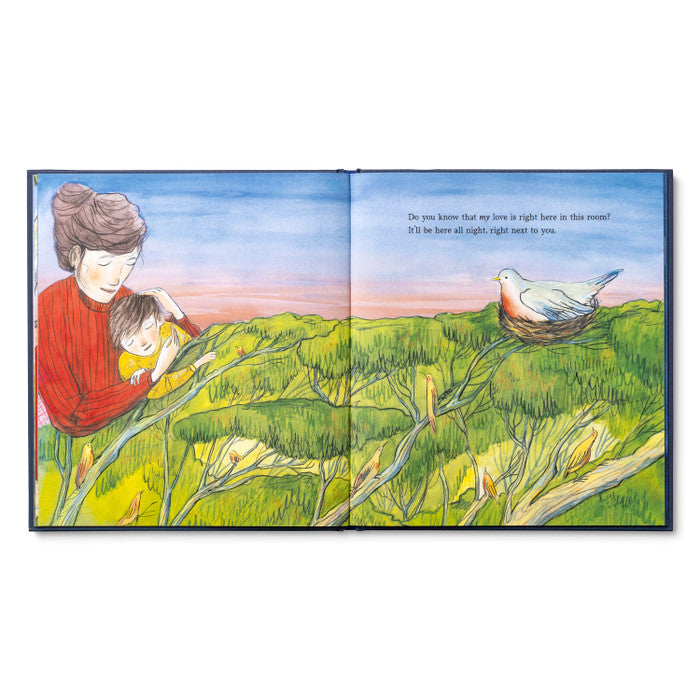 Open spread of an adult in red cradling a child in a meadow, with a small bird nearby