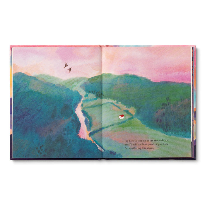 Open spread of a green valley with a winding path and a small figure walking it