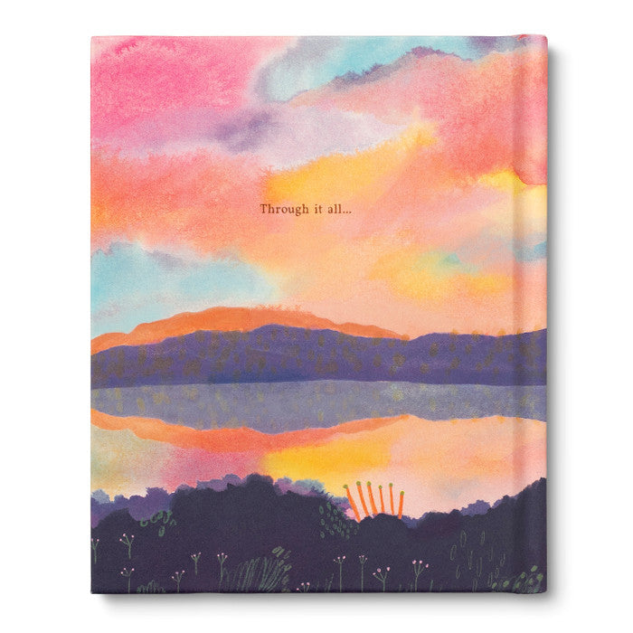 Front cover laid flat showing the painted sunrise, still water and the words through it all