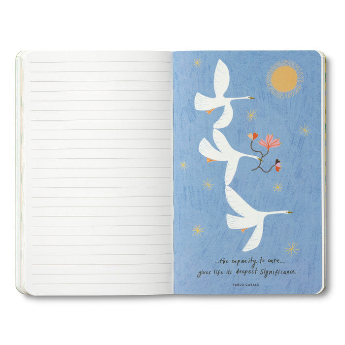 Open journal with a blue breakout page of white geese and a Pablo Casals quote on caring