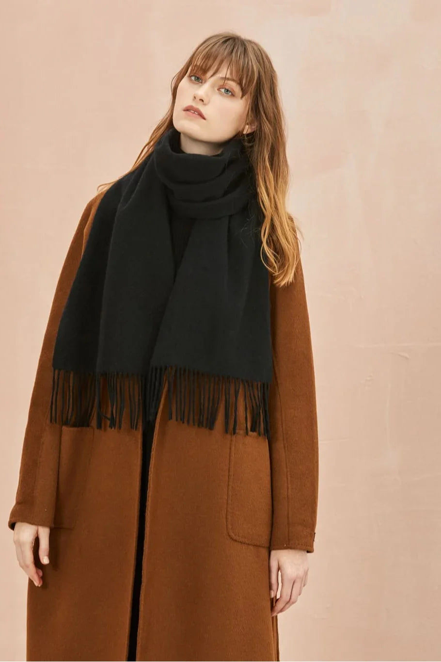 Ebony black scarf draped over a tan coat, front view