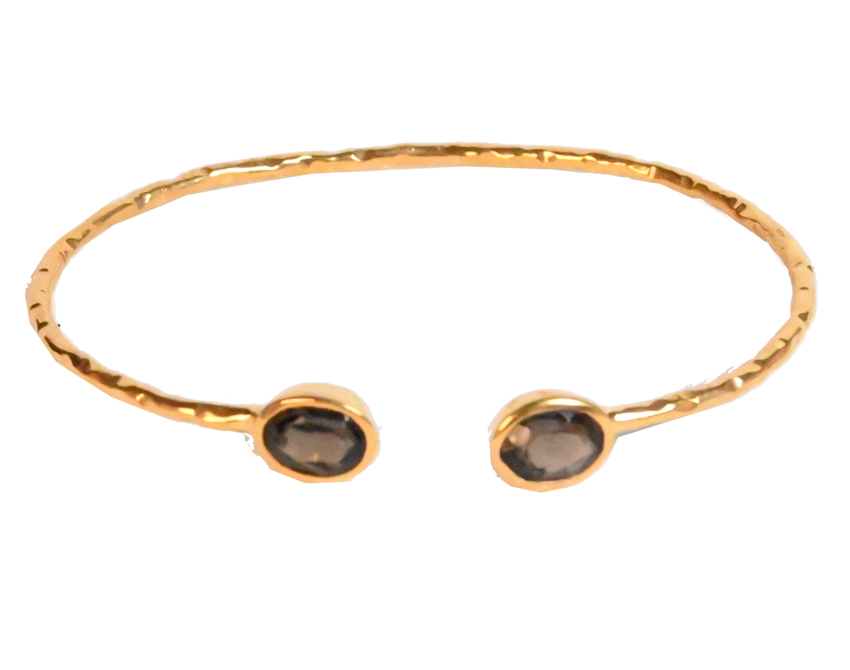 Euro Gold cuff bangle with two smoky brown gems on black background