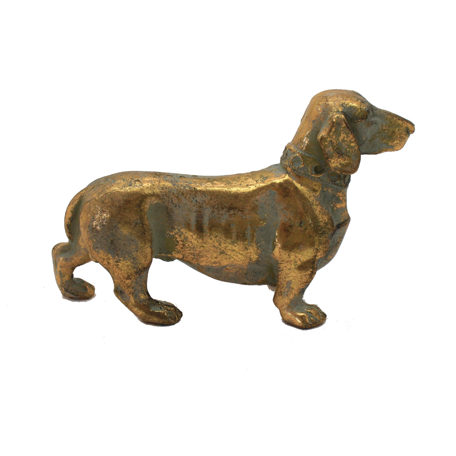 Antique gold dachshund figurine in profile facing right, the mottled gold finish catching the light.