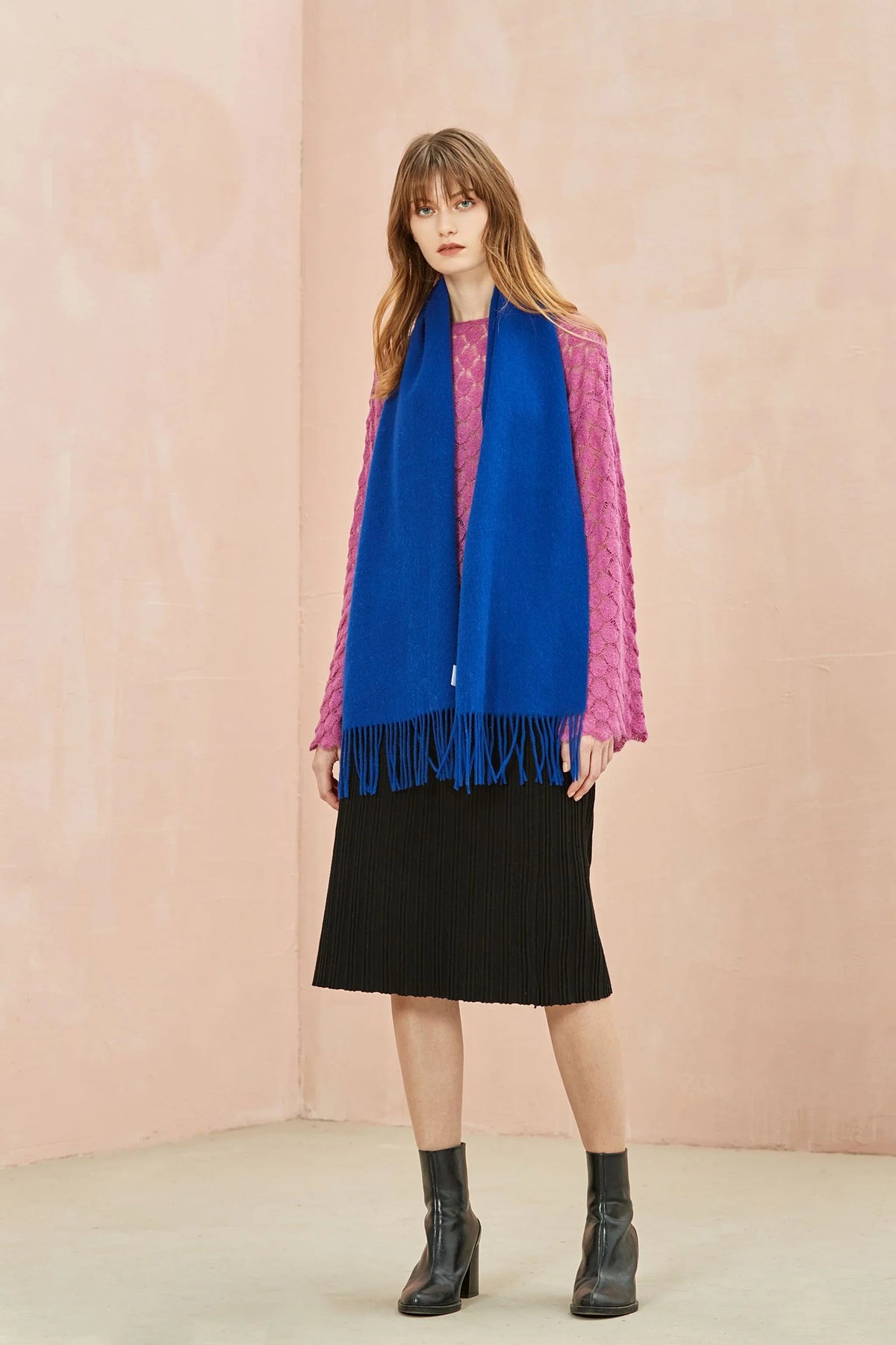Full-length look with the Veronica Blue scarf against a pink wall
