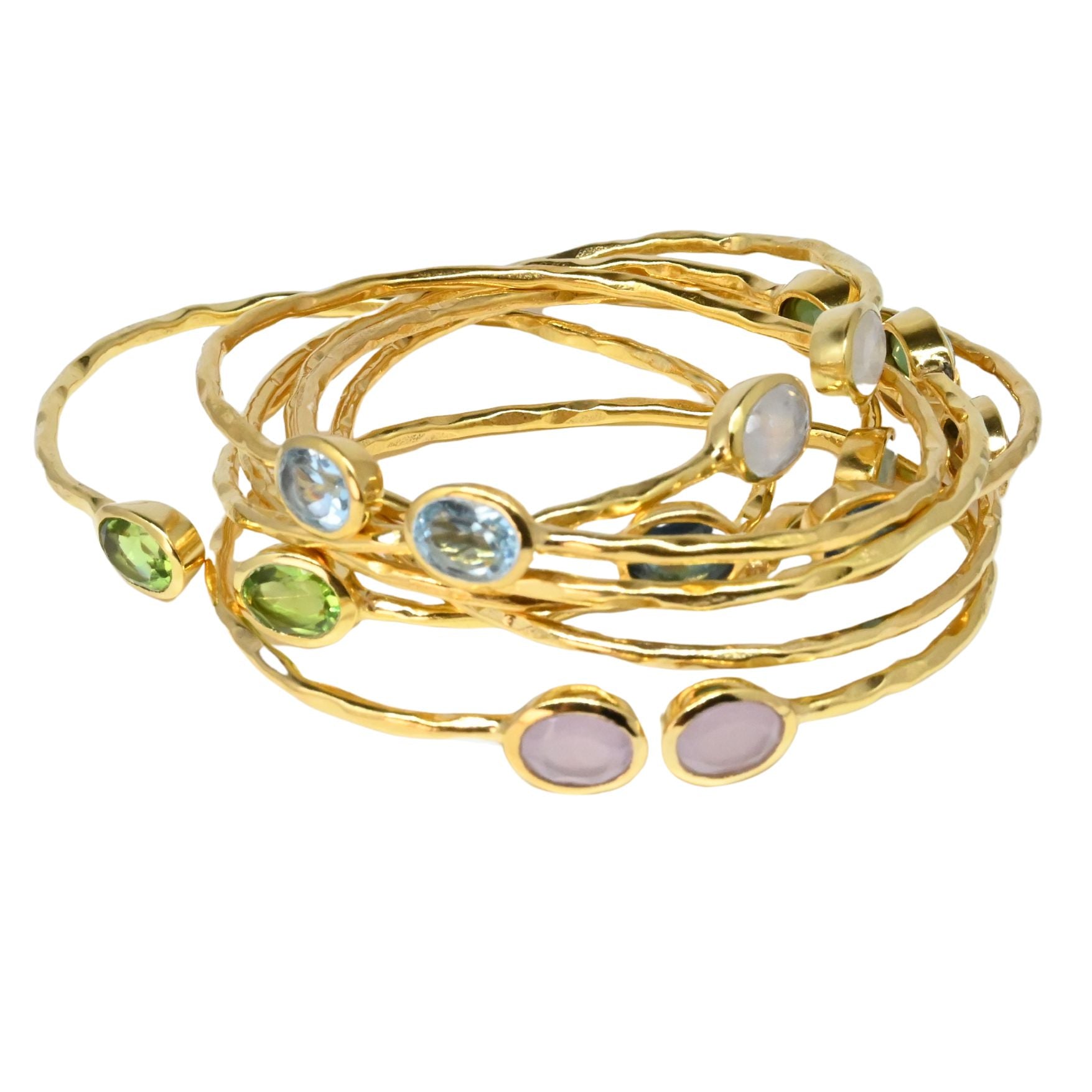 Stack of seven hammered Euro Gold gem cuff bangles with peridot, blue topaz, moonstone and rose stones