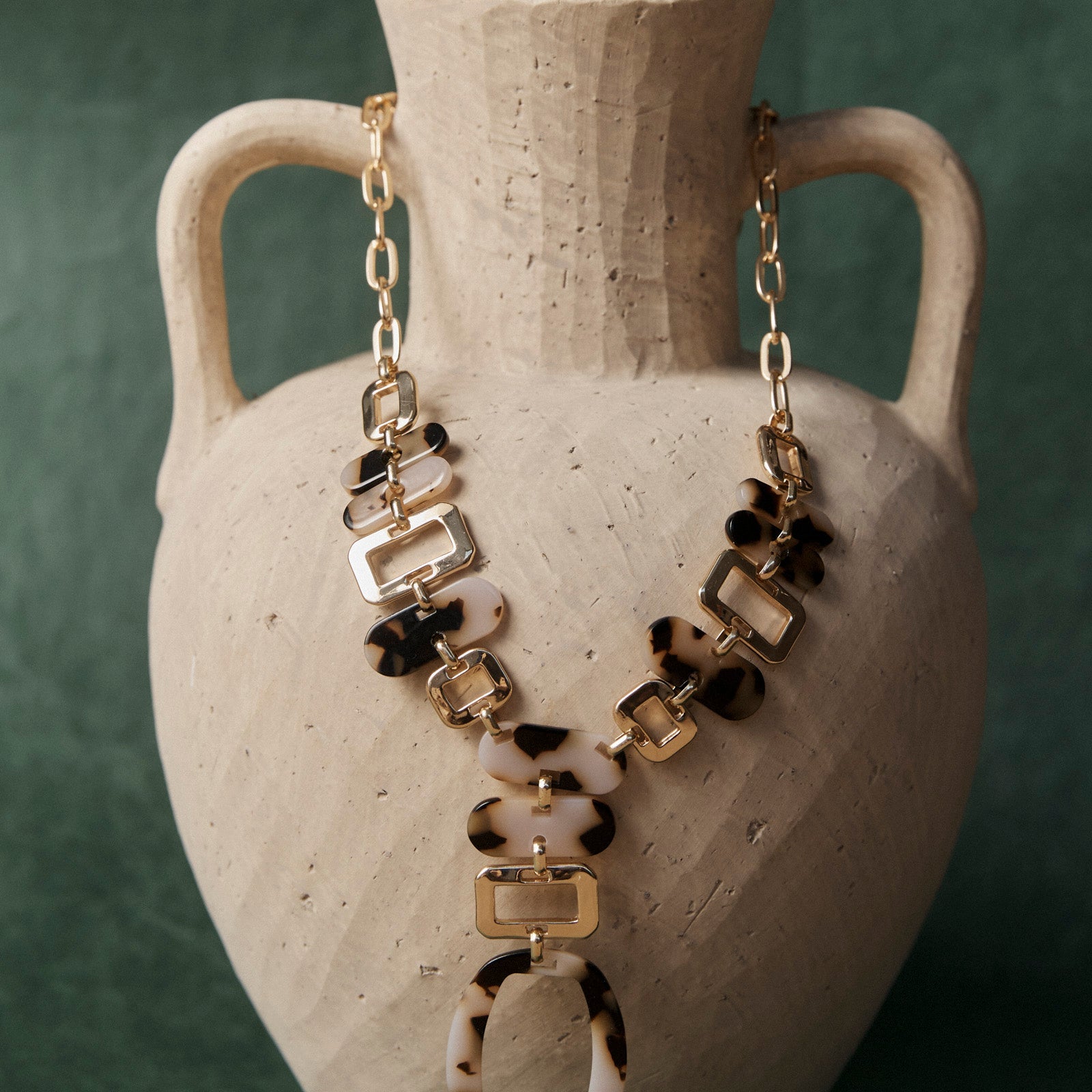 Nomad Chain draped over a stone urn