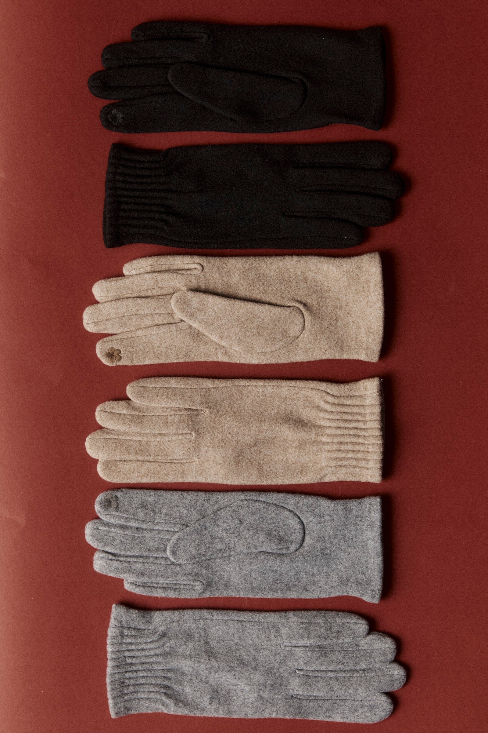 Berber gloves laid out in black, camel and grey shades