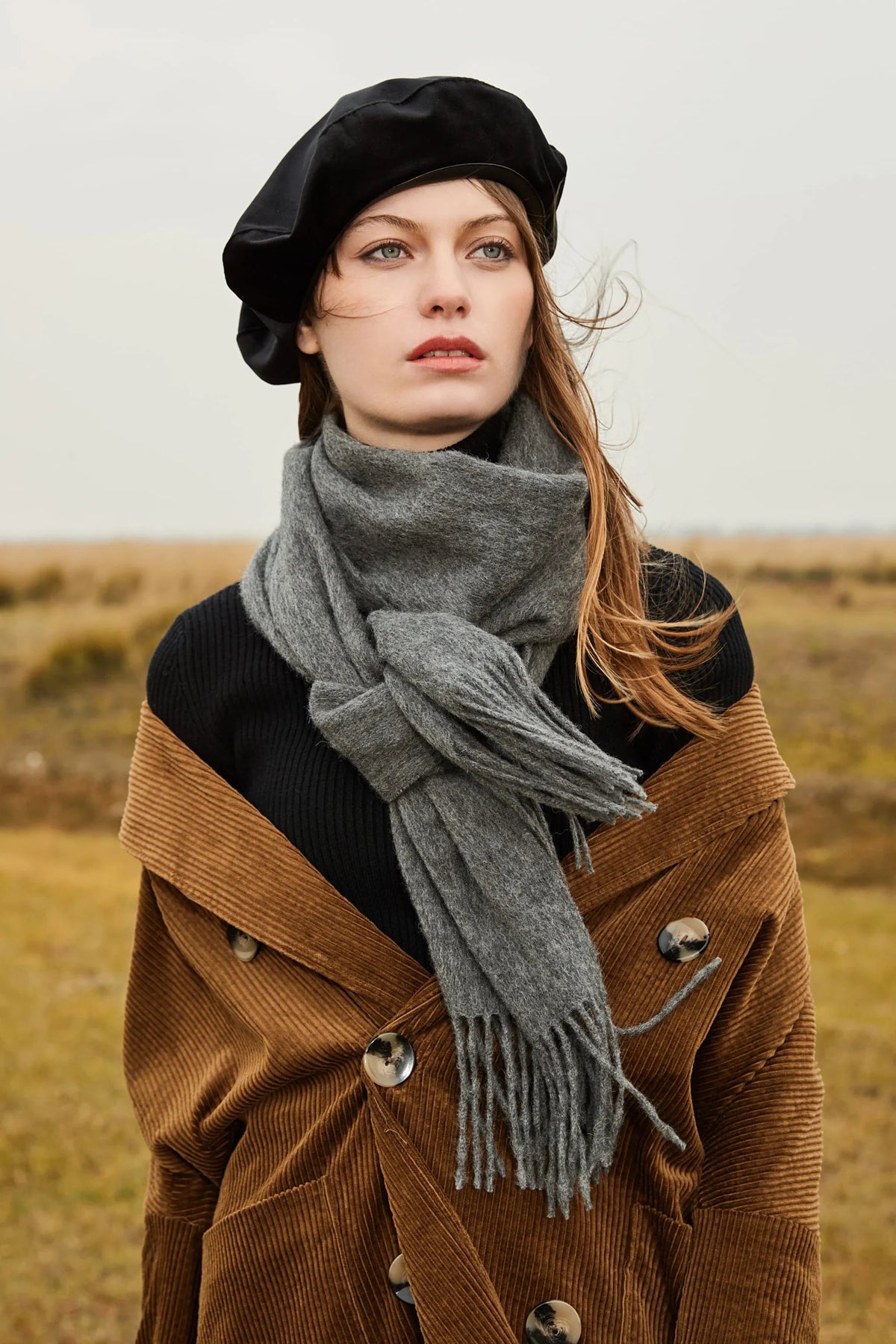 Close view of the Light Charcoal scarf tied over a brown corduroy coat