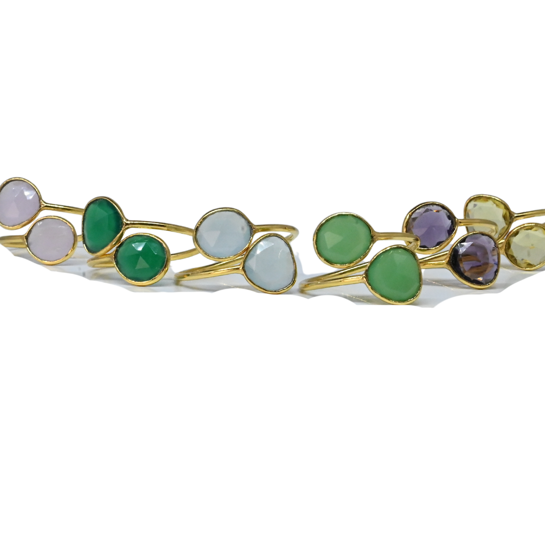 Line-up of Euro Gold open cuff rings showing the range of gem colours