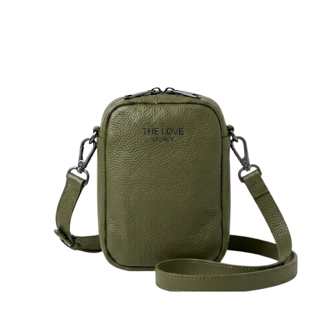 Mel Mini Cross Body Bag in olive green — a small phone-sized bag in pebbled leather with twin top zips and an embossed 4THELOVE logo, its long detachable strap coiled beside it.