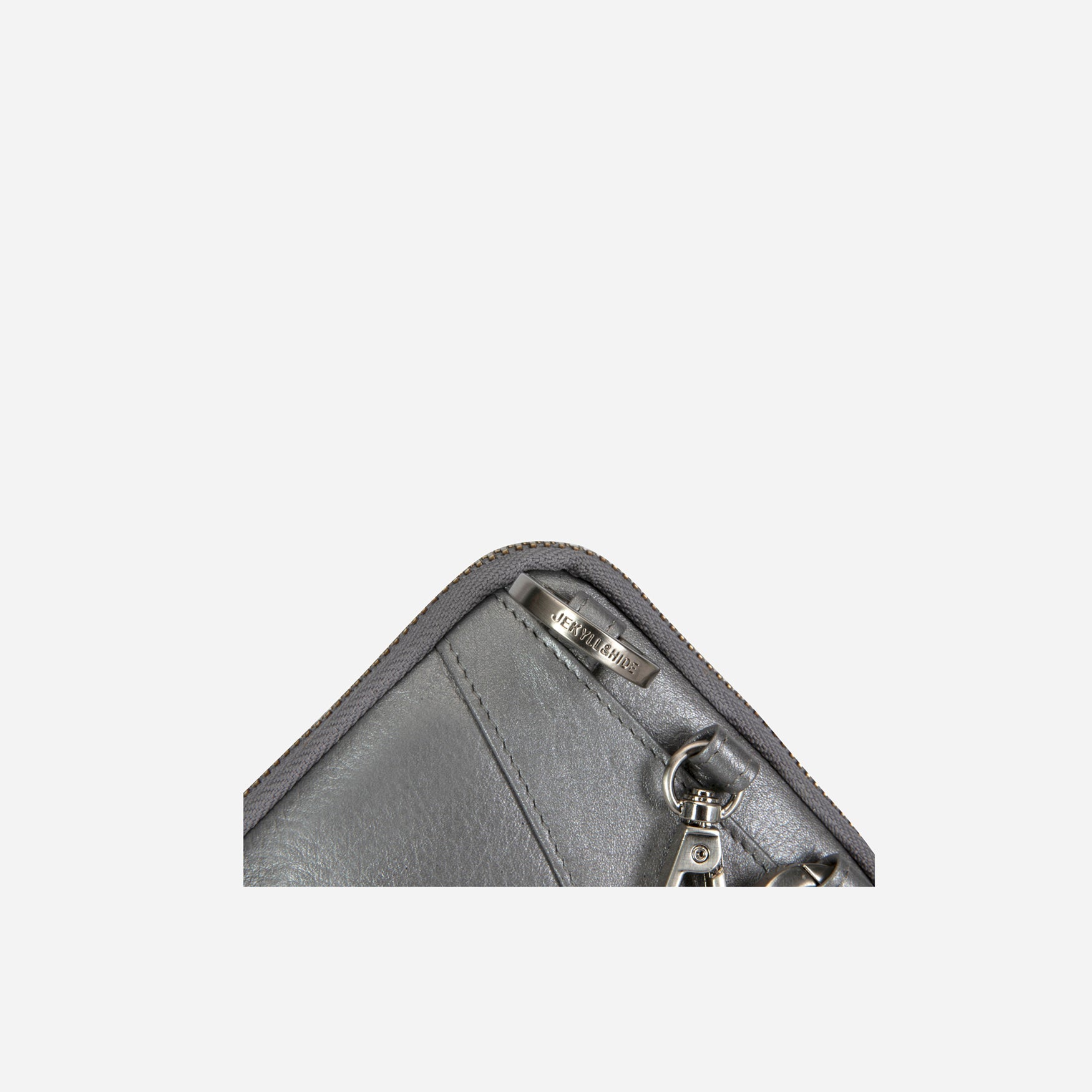 Corner close-up of the metallic silver pouch zip and clip