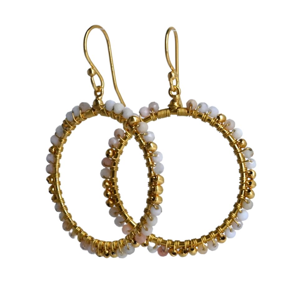 Overlapping gold hoop earrings wire-wrapped with cream and blush opal potch beads