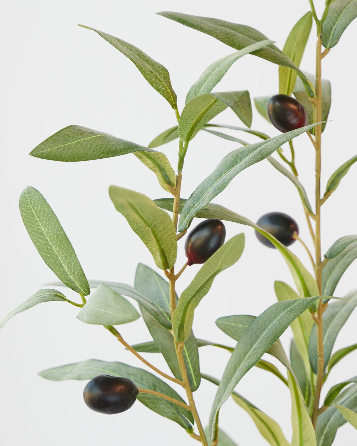 Close view of the artificial olive spray showing the leaf detail and dark olives