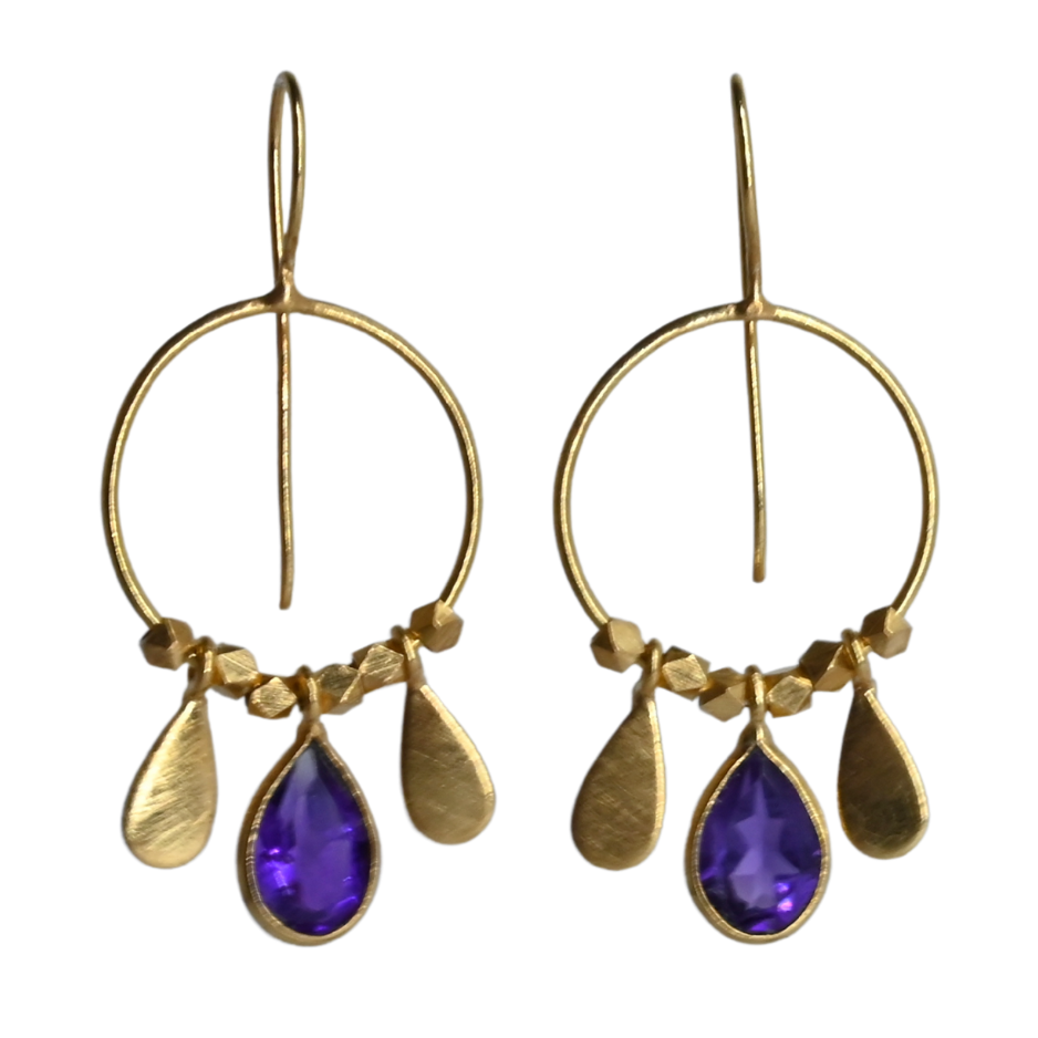 Fine gold hoop earrings with a faceted violet amethyst teardrop between two gold petals