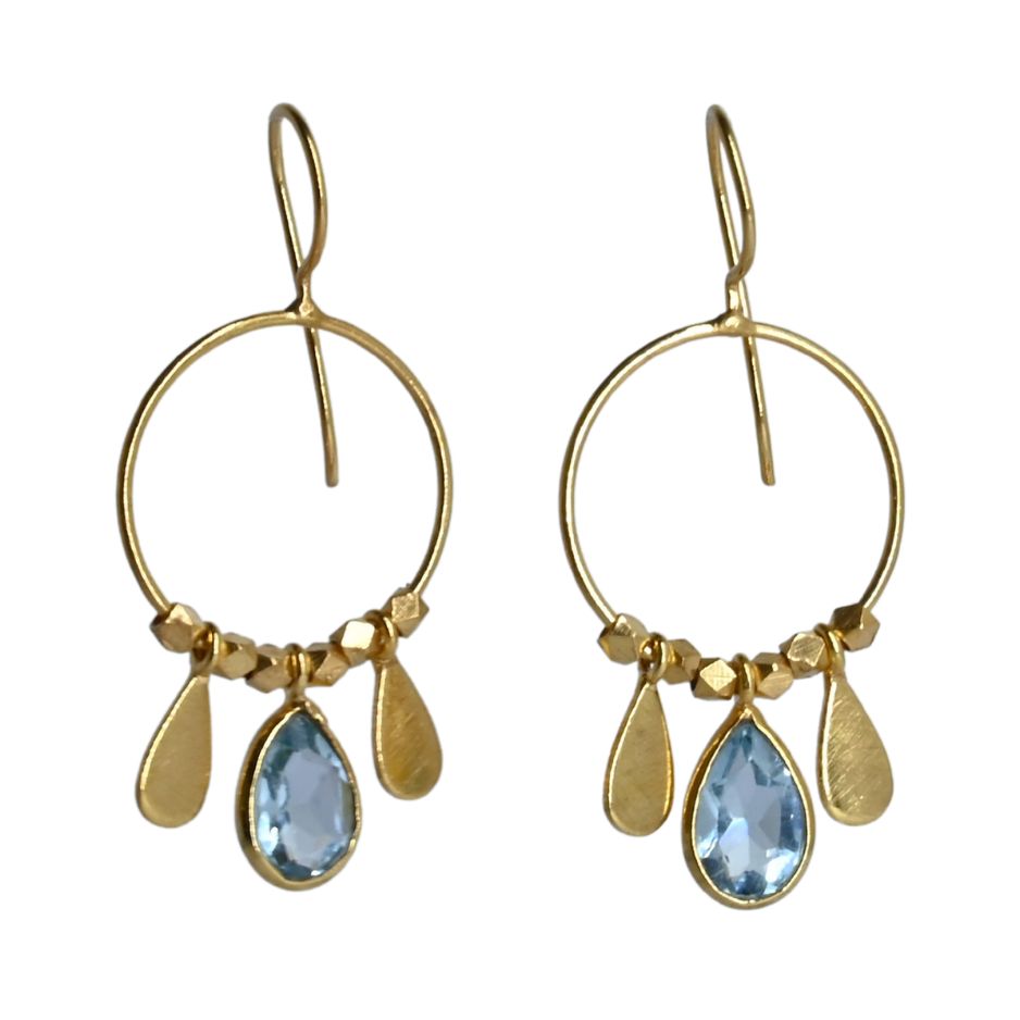 Fine gold hoop earrings with a faceted pale sky-blue topaz teardrop between two gold petals