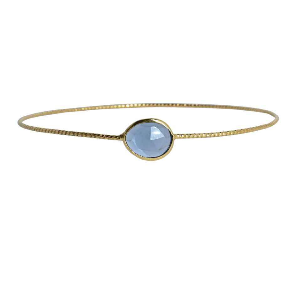 Euro Gold cuff bangle with a faceted soft blue London blue topaz