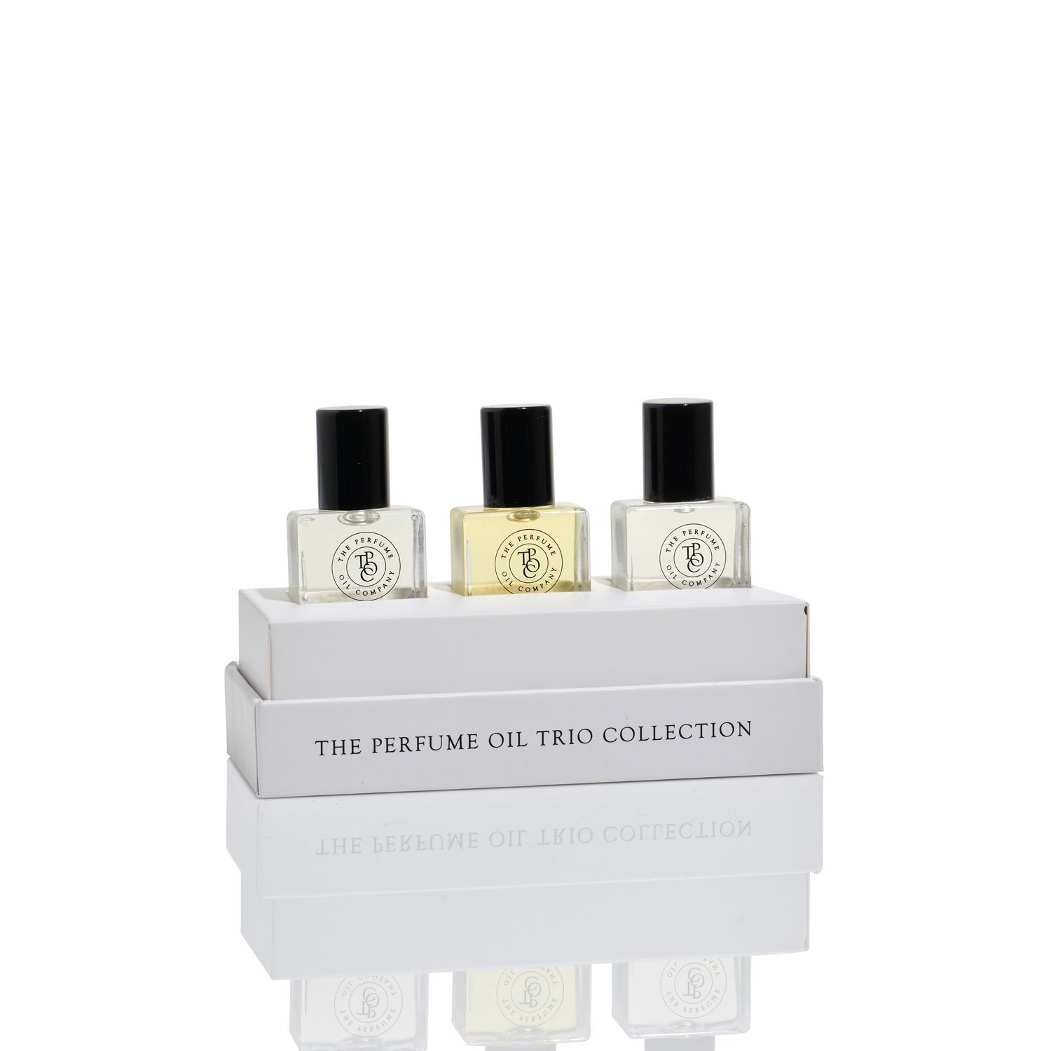 The Perfume Oil Trio gift box open with three 5 ml roll-on bottles standing on the lid