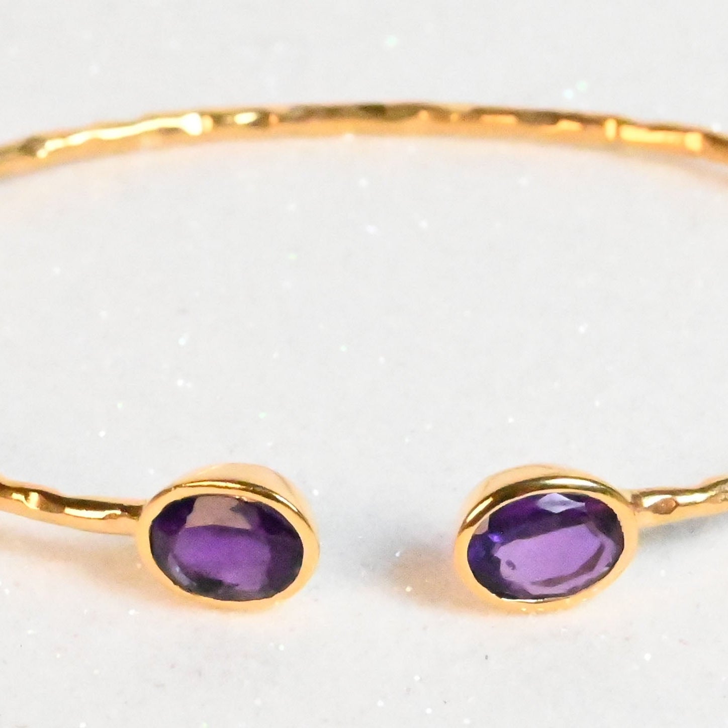 Rose-toned Euro Gold cuff bangle with two amethyst-purple oval gems