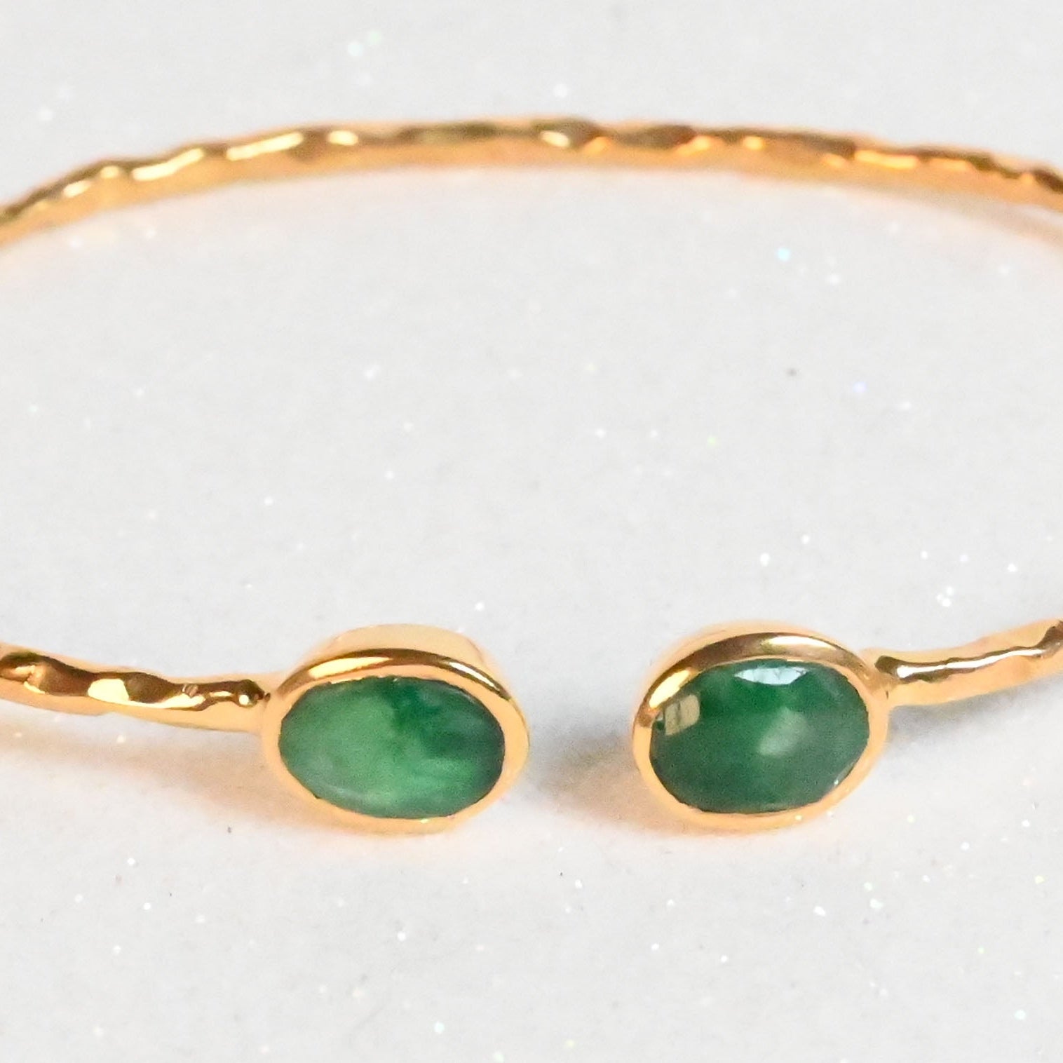 Euro Gold hammered cuff bangle with two emerald-green gems on white