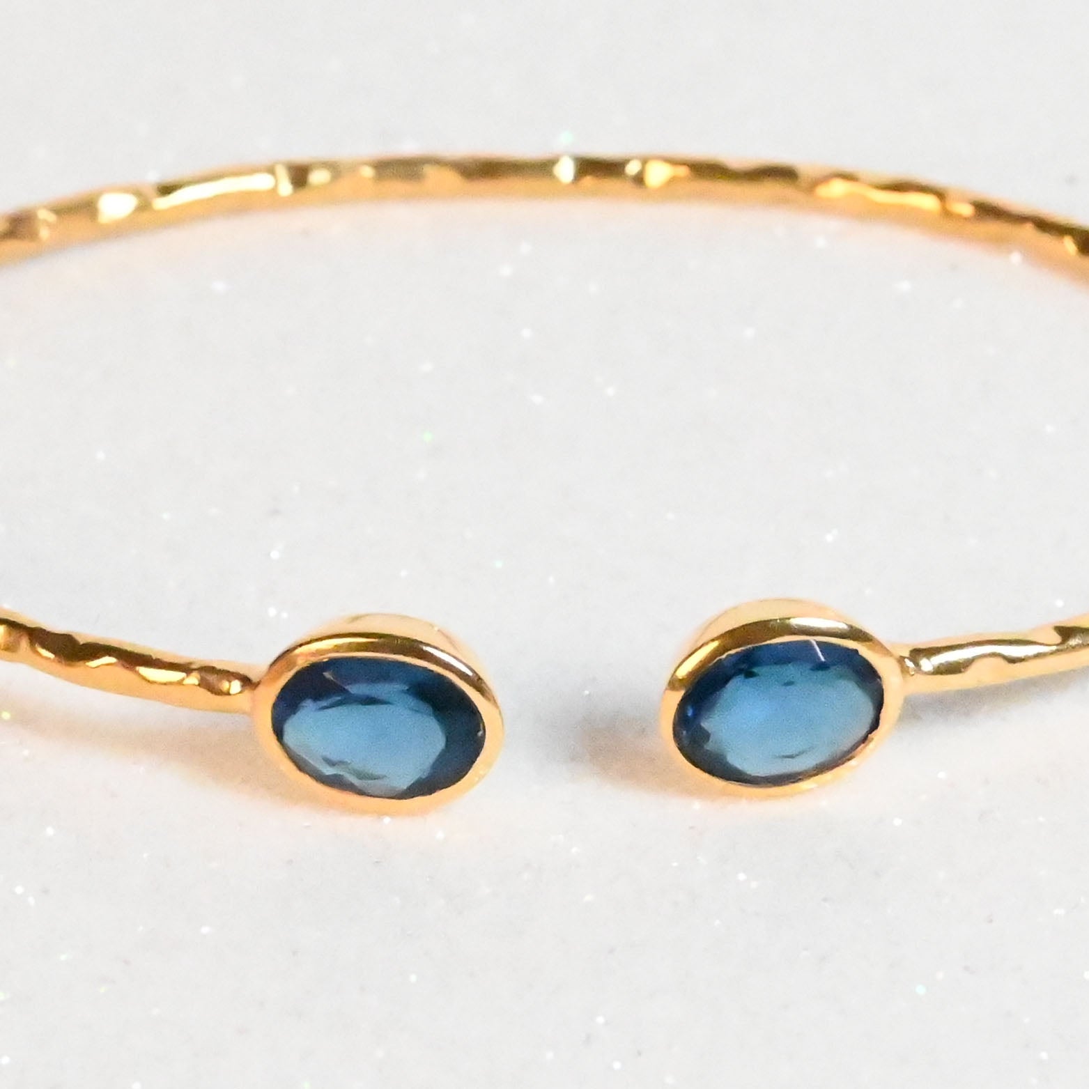Euro Gold hammered cuff bangle with two London-blue oval gems