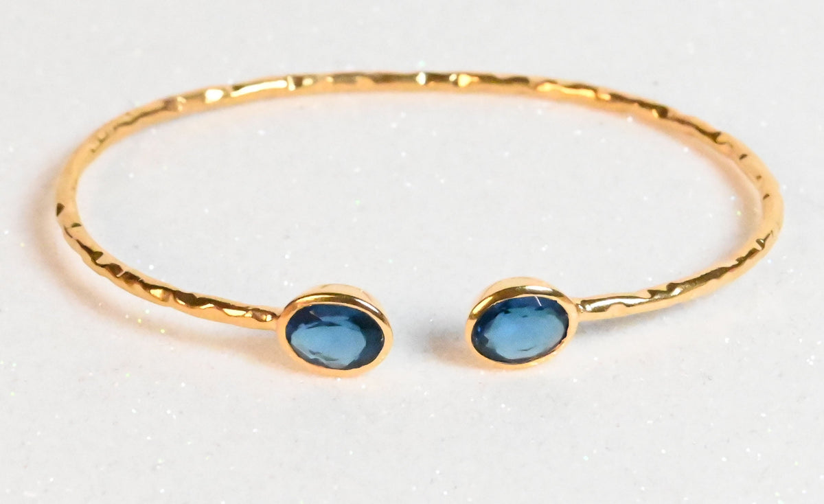 Euro Gold hammered cuff bangle with two London-blue oval gems
