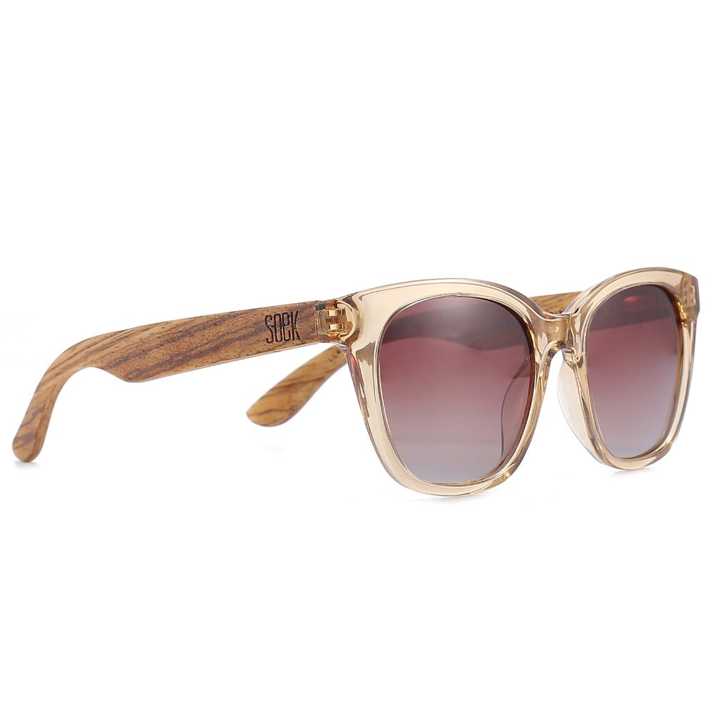 Lila Grace sunglasses at an angle: a champagne-toned frame with grained wood arms