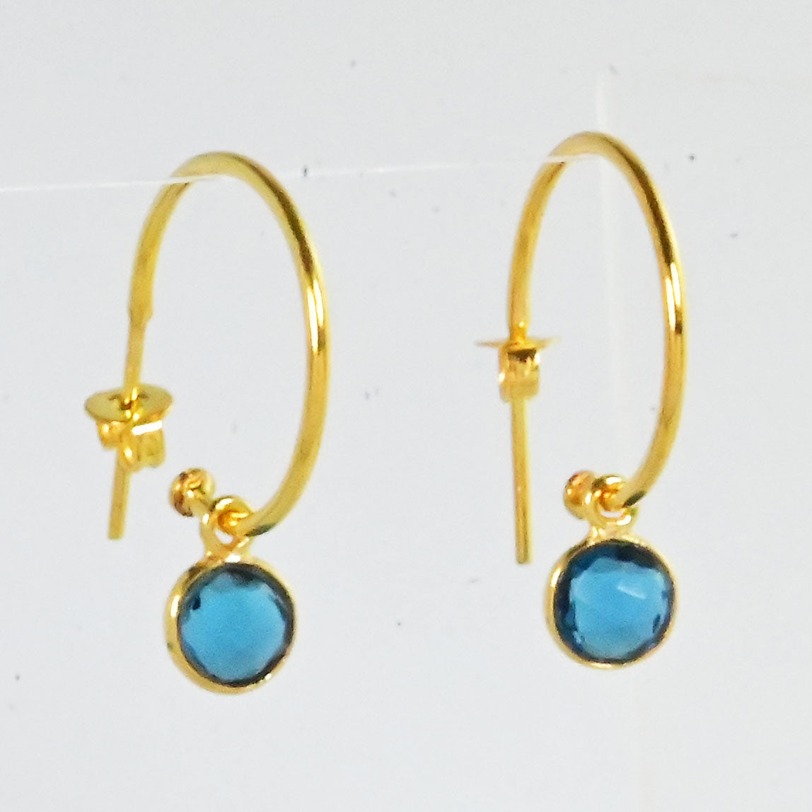 Euro Gold hoop earrings with a faceted London blue topaz drop