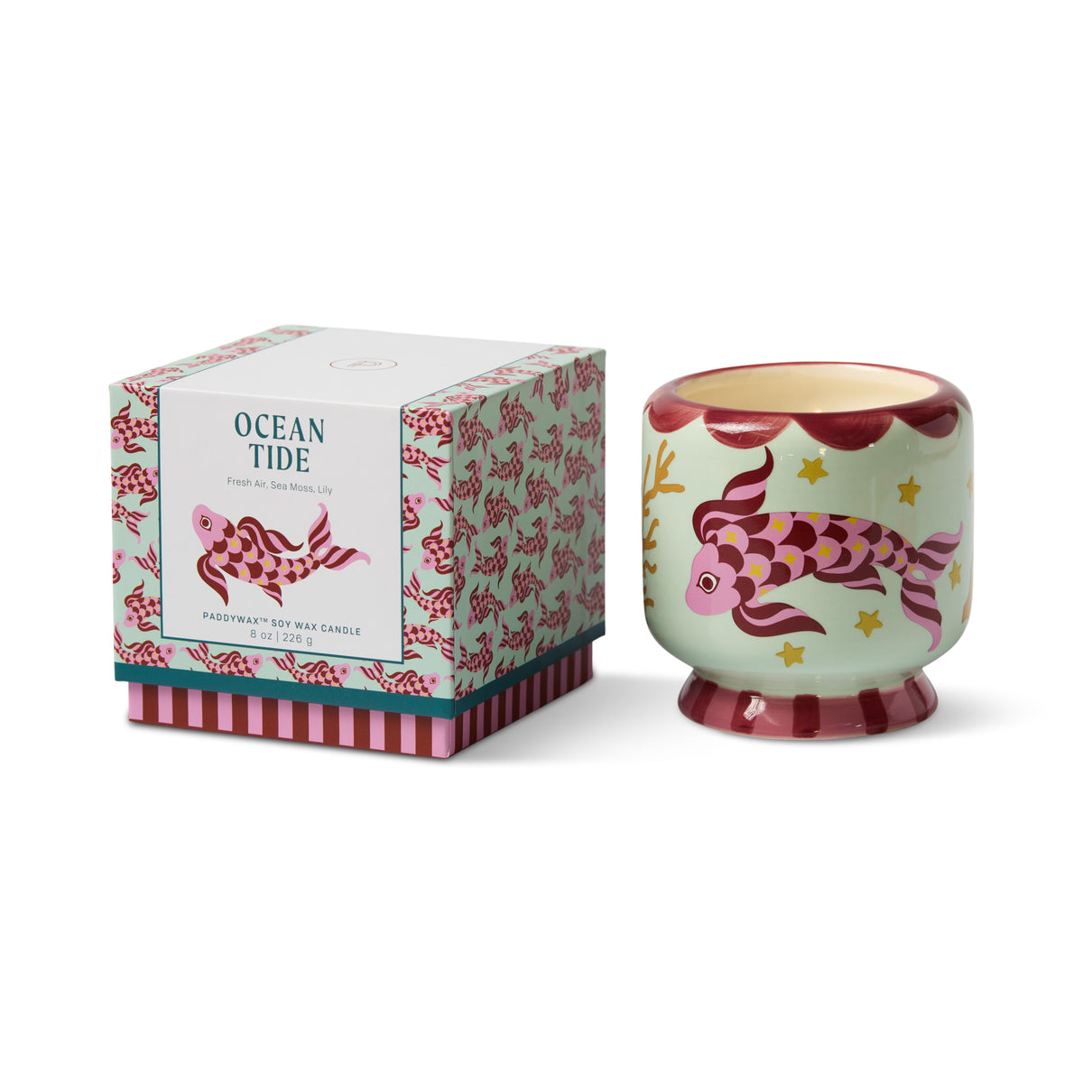 Mint green ceramic candle painted with a pink and maroon koi and gold stars, beside its matching Ocean Tide gift box.