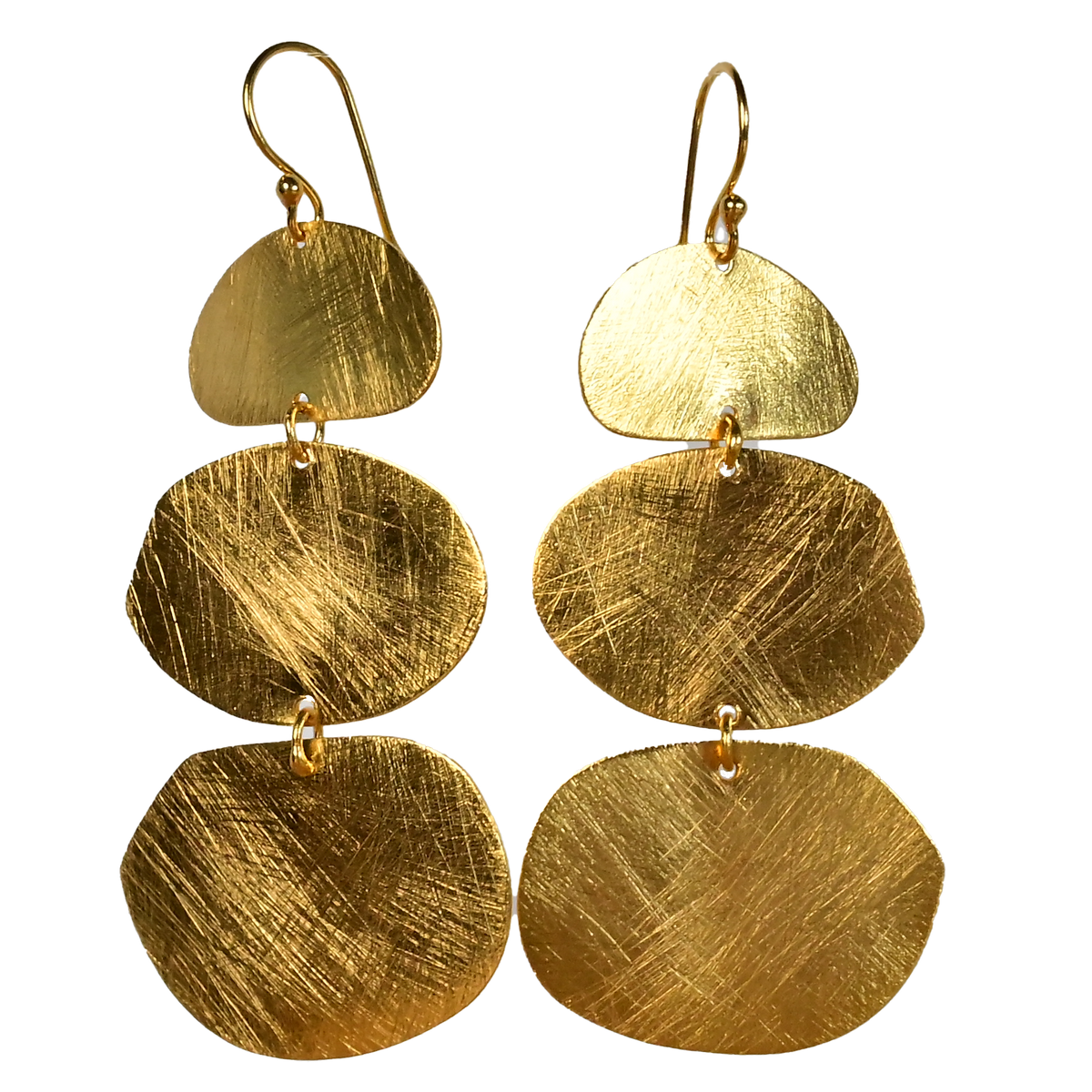 Brushed gold earrings with three graduated organic discs on a fine hook