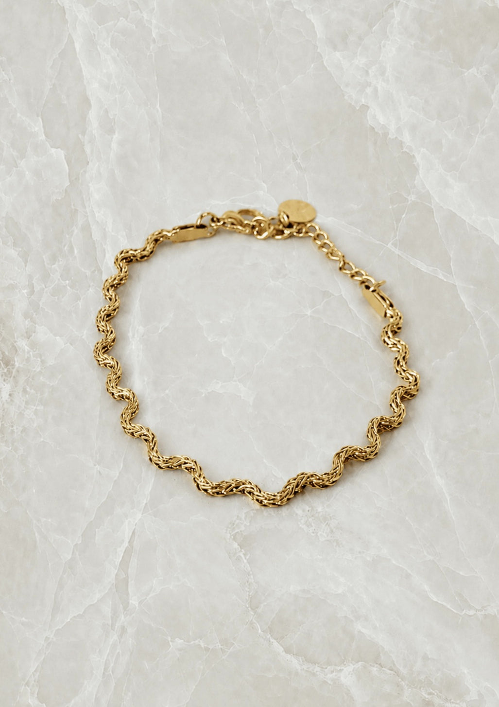 Gold curb-link chain bracelet with softly curved links and a lobster clasp