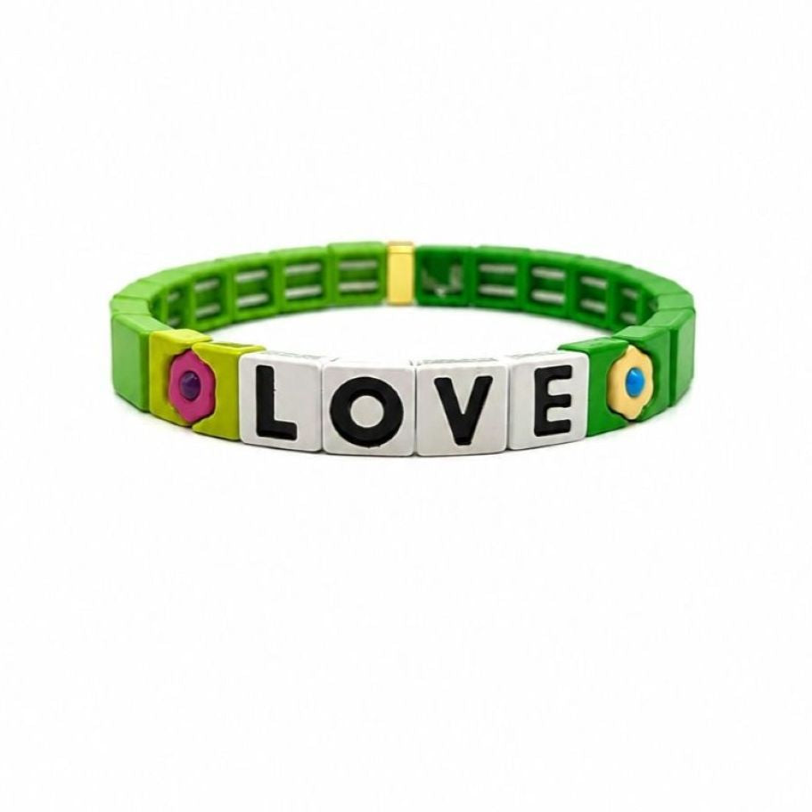 Bright green tile bracelet with four white tiles spelling LOVE in black, between a pink flower and a pale yellow flower