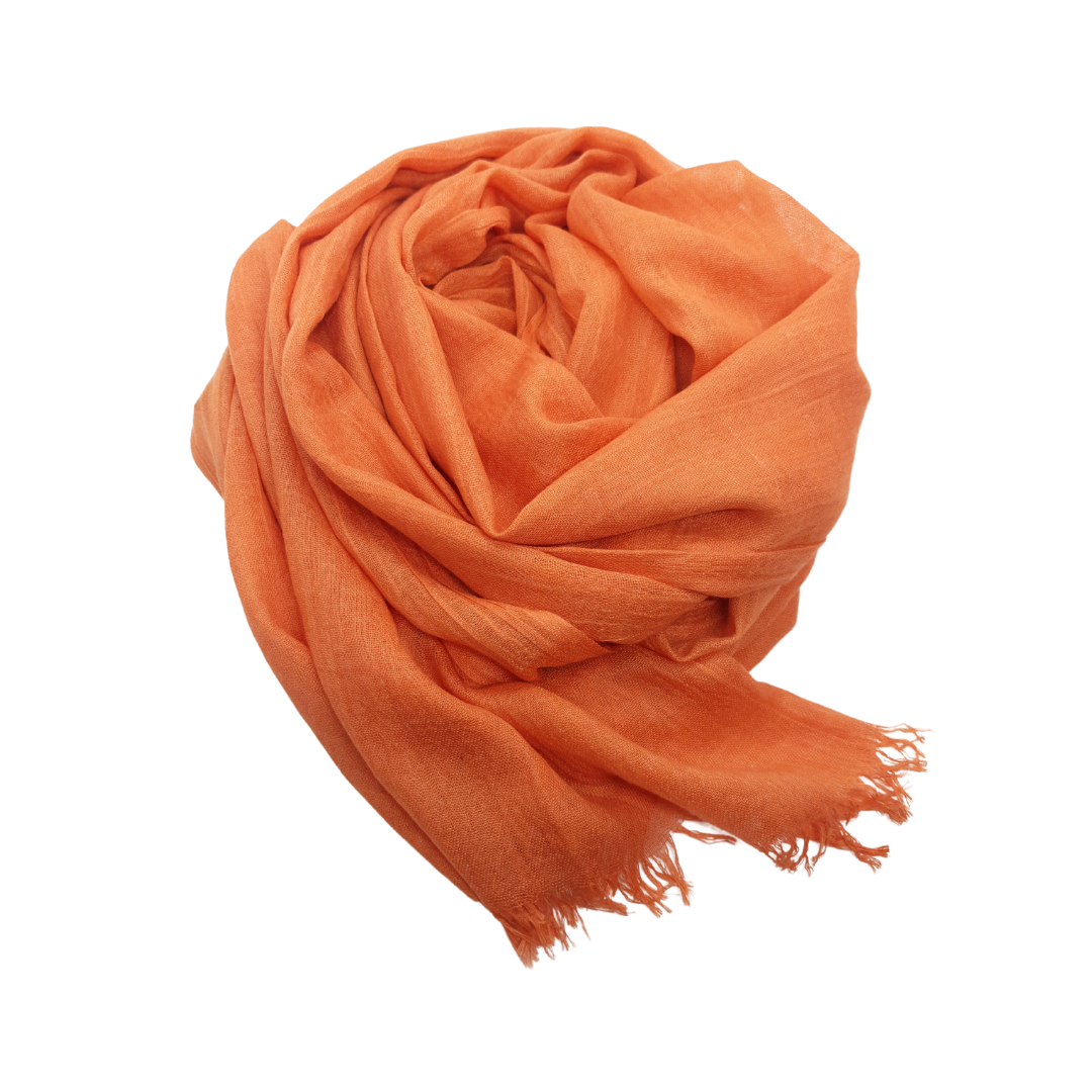 Beauty in Bamboo scarf in Burnt Orange, coiled with fringed ends trailing