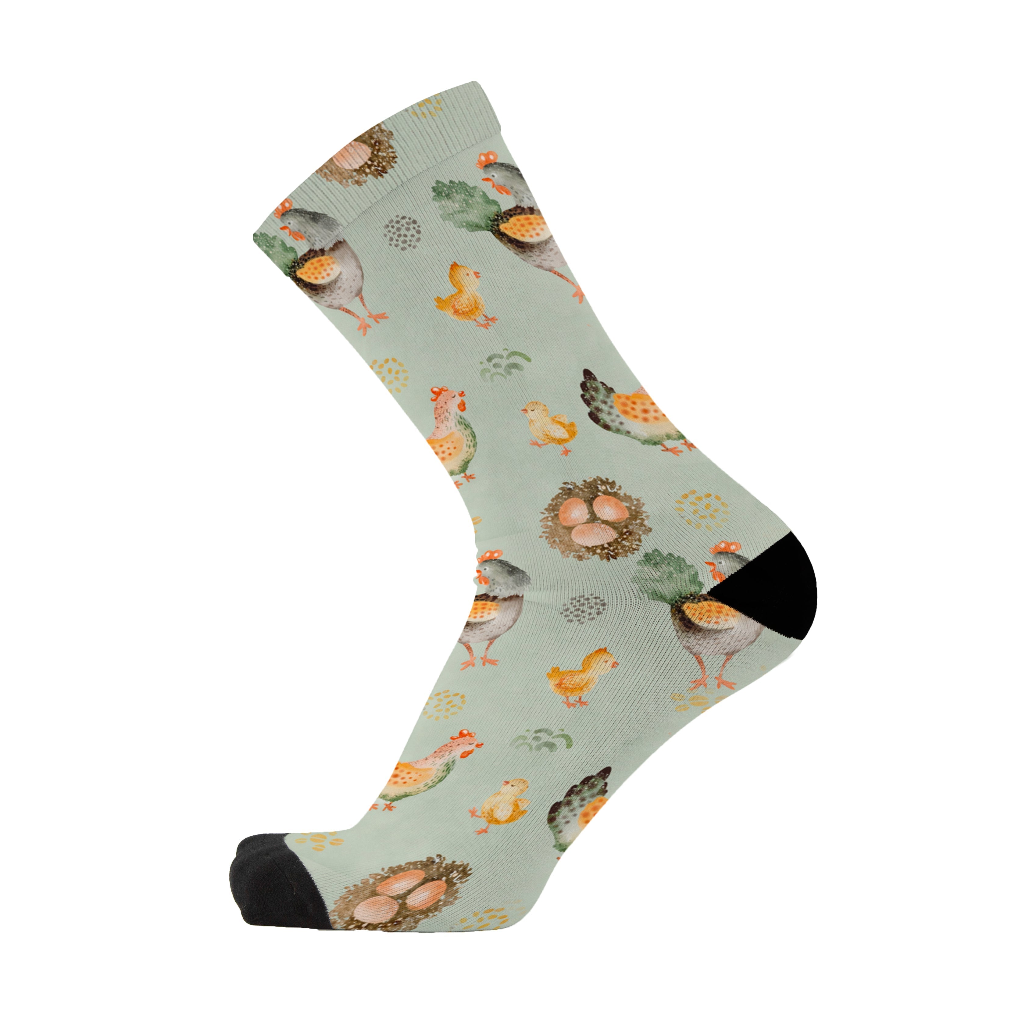 Single sage green crew sock with a black toe, printed with hens, fluffy chicks, eggs and straw nests in cream, orange and brown.
