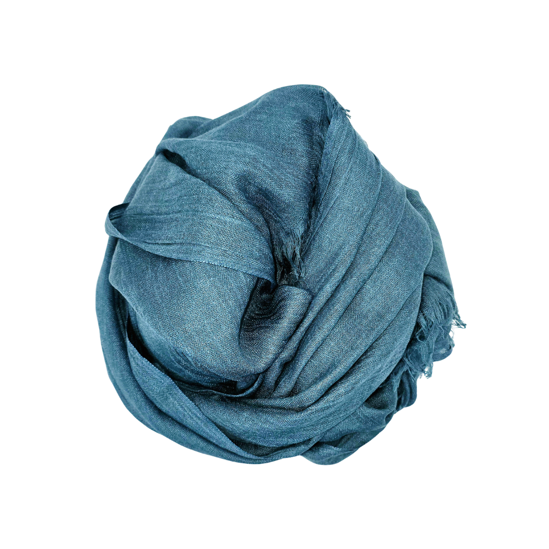 Beauty in Bamboo scarf in a deep steel teal-blue, bundled with fringing visible