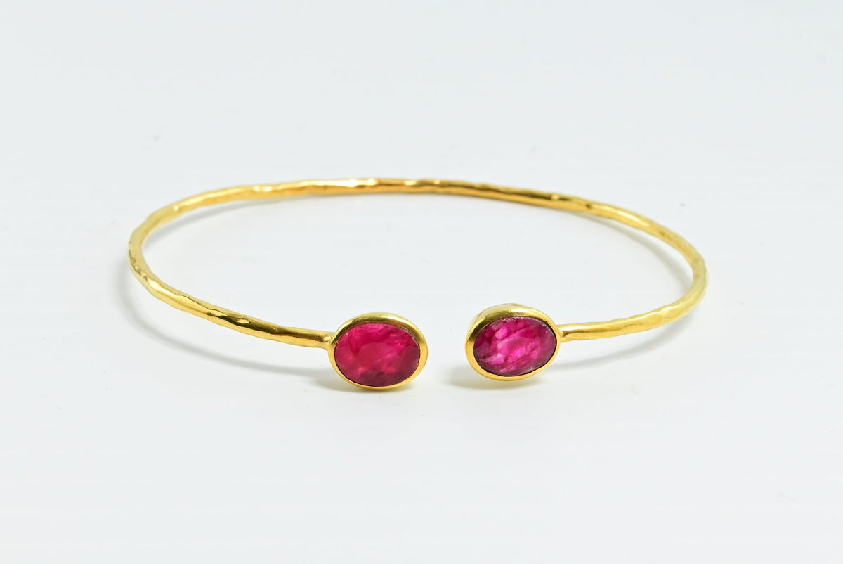 Euro Gold cuff bangle with two ruby-pink oval gems facing each other