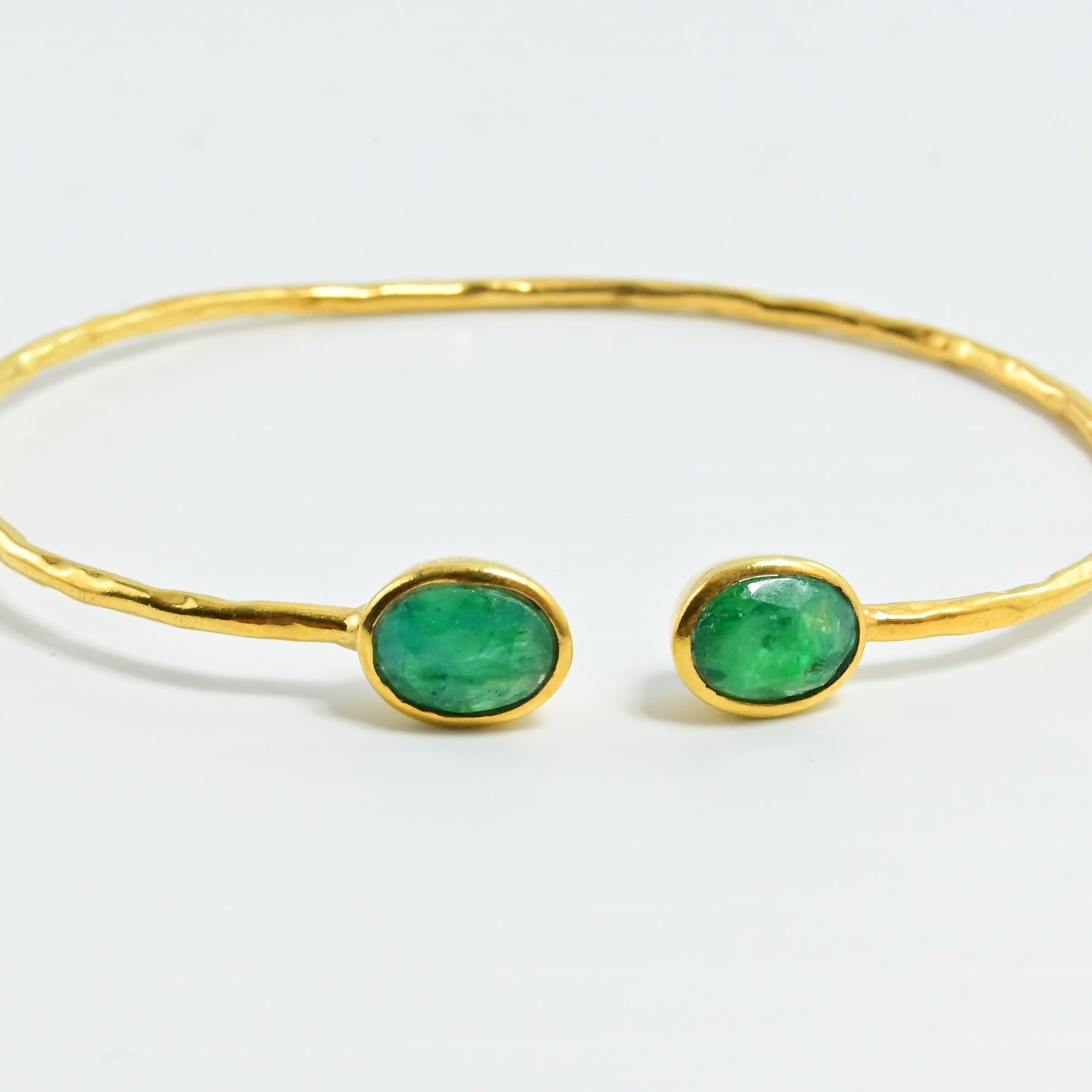 Euro Gold cuff bangle with two emerald-green oval gems