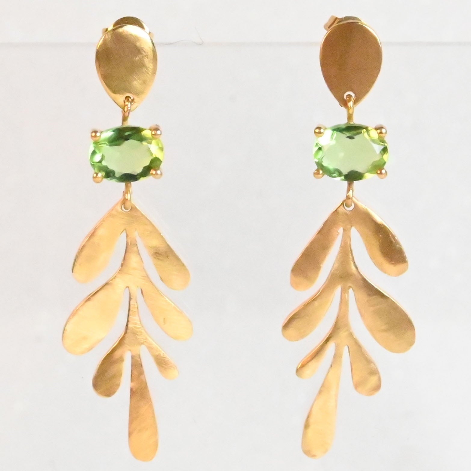 Euro Gold leaf drop earrings with peridot-green oval gems