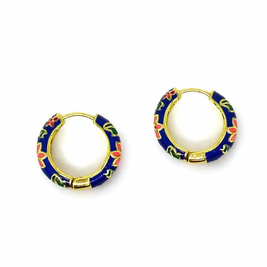 Pair of cobalt-blue huggie hoops patterned with coral flowers and green leaves outlined in gold tone
