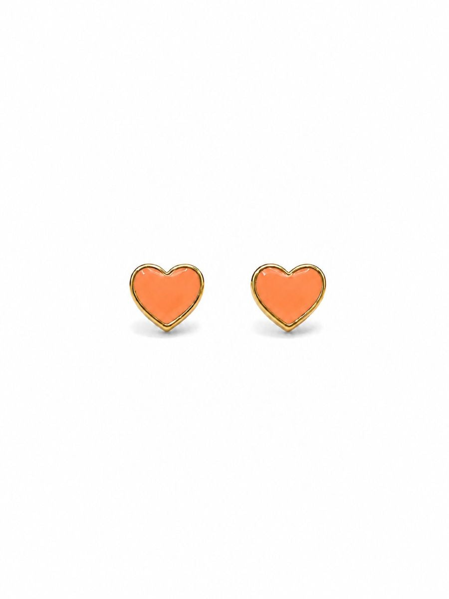 Pair of glossy orange heart-shaped studs with slim gold-tone rims, on white