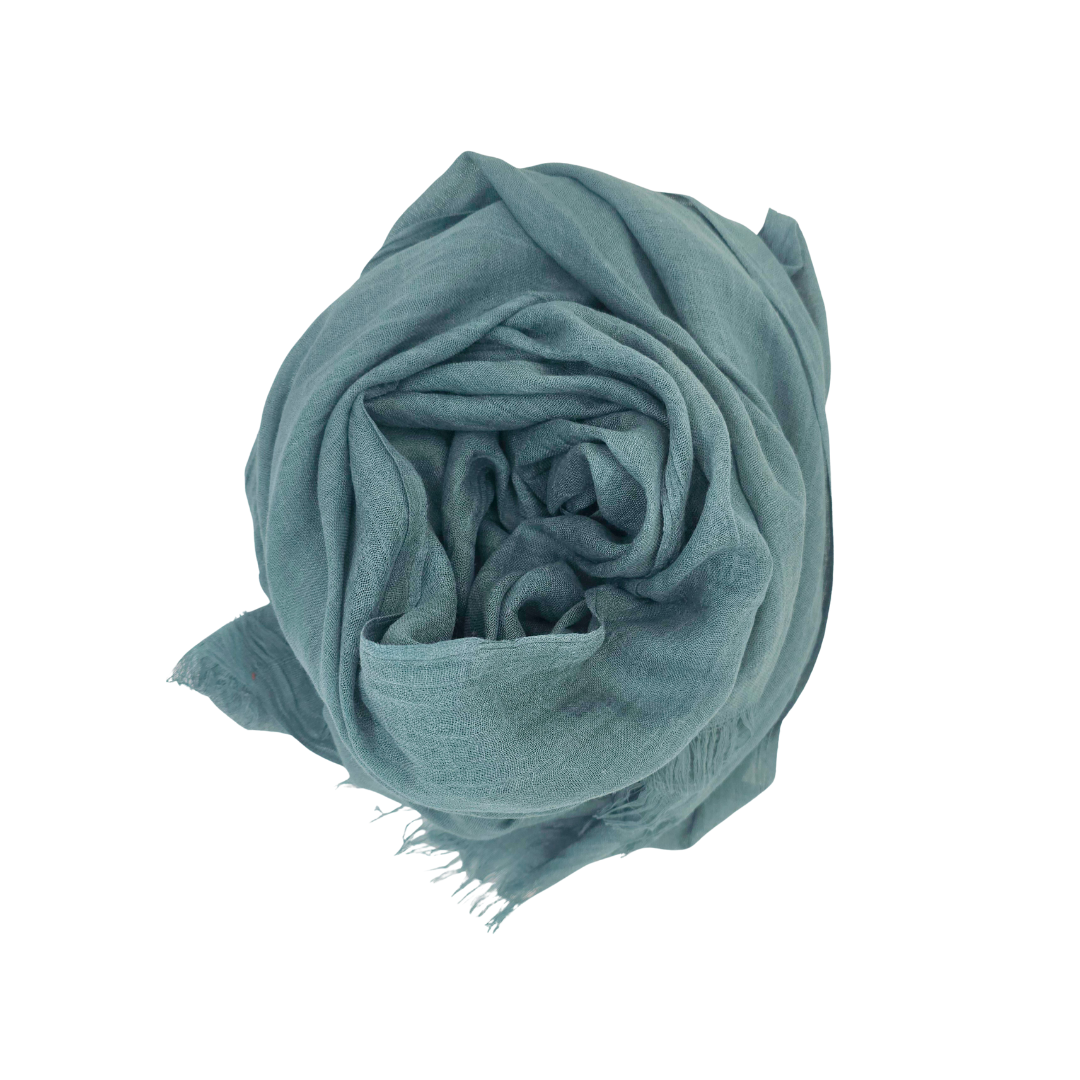 Beauty in Bamboo scarf in Forrest Green, a muted teal-green, rolled into a bun