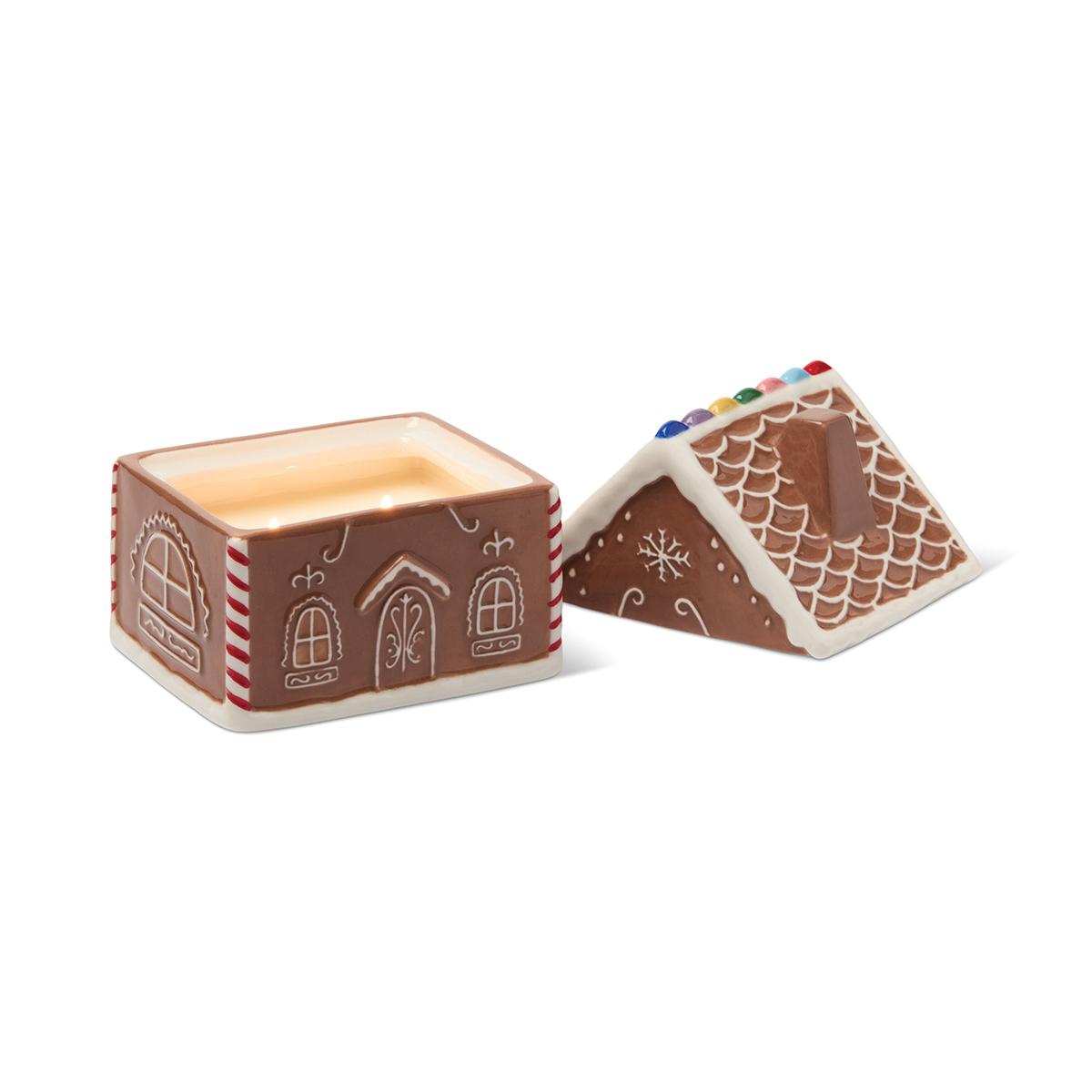 The gingerbread house with its roof lifted off and set beside it, showing the candle inside.