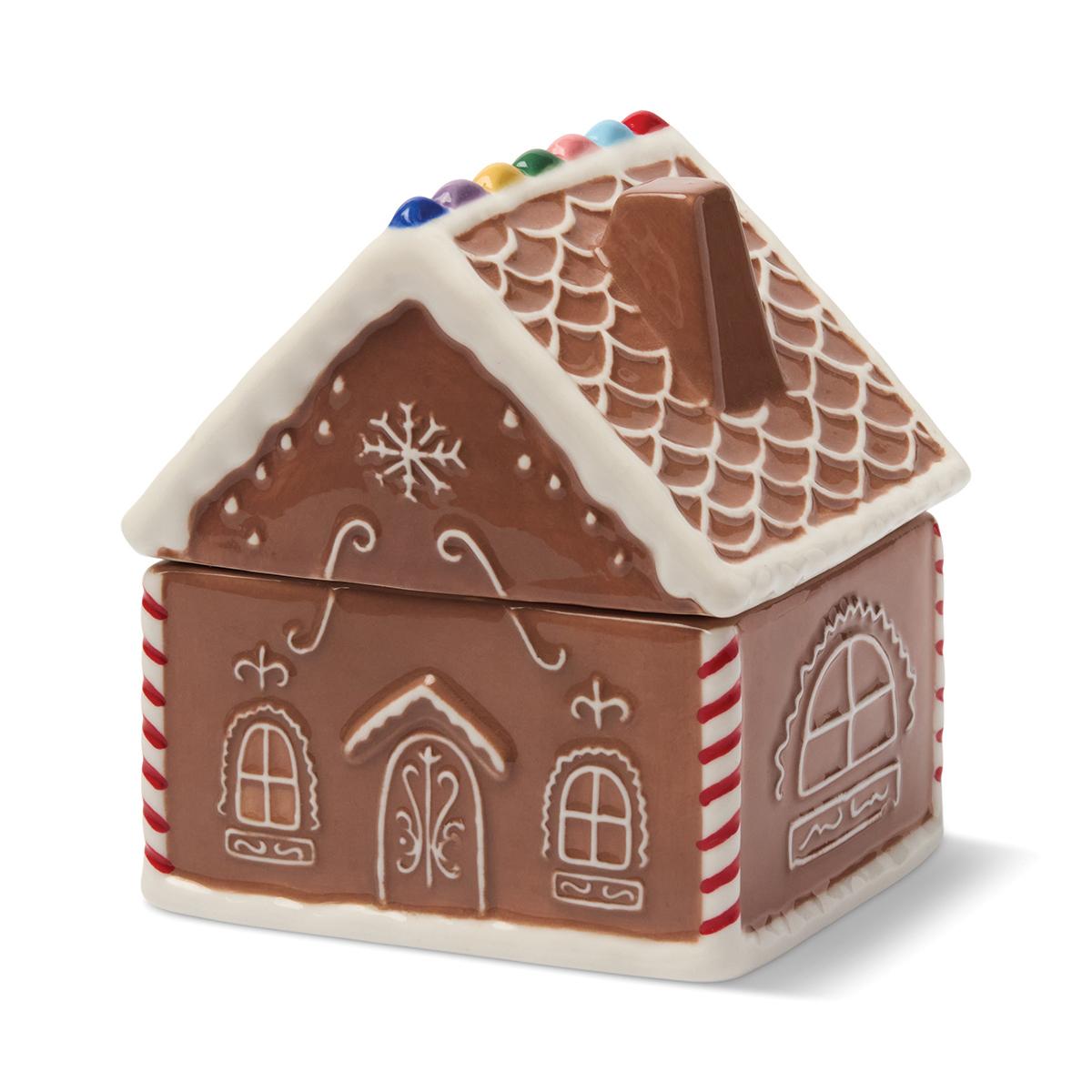 The gingerbread house from the other side, showing its arched windows and candy-striped corners.