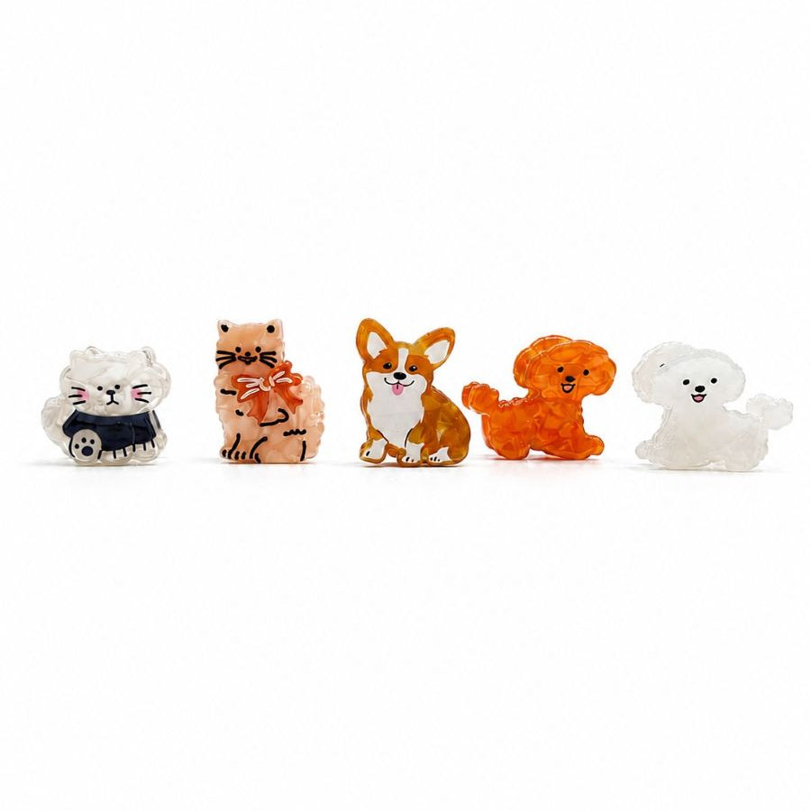 The five mini cat and dog hair clip designs in a row, left to right: White Cat, Peach Cat, Corgi, Orange Pup and White Pup
