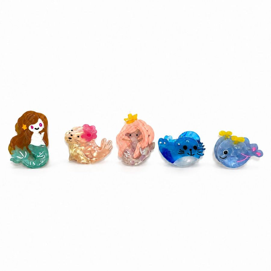 The five mini ocean hair clip designs in a row, left to right: Mermaid, Flower Seal, Crowned, Blue Seal and Whale