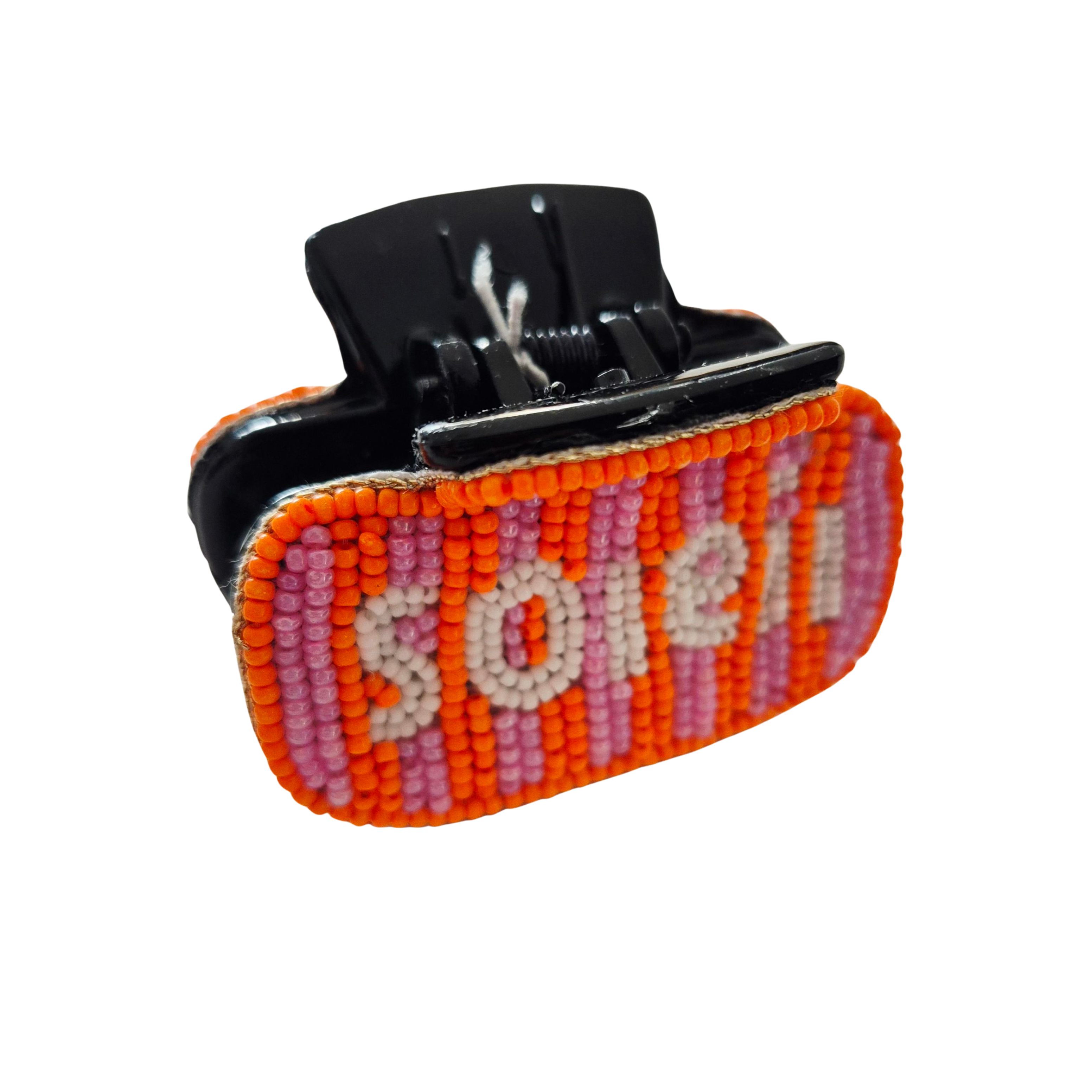 Black claw hair clip covered in orange and pink striped beadwork spelling soleil in pale beads.