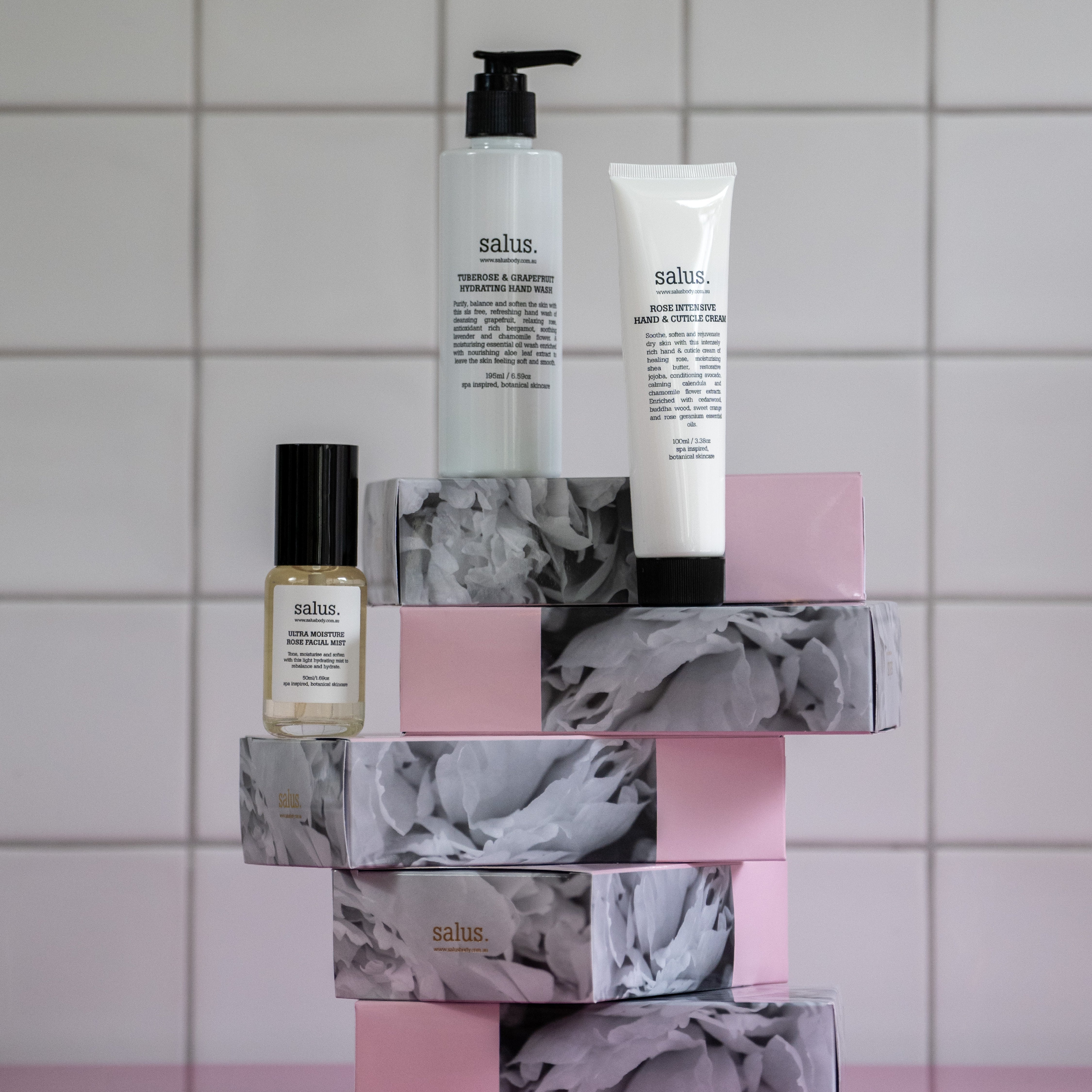 Salus Hydration Trio hand wash, hand cream and facial mist stacked on petal print boxes