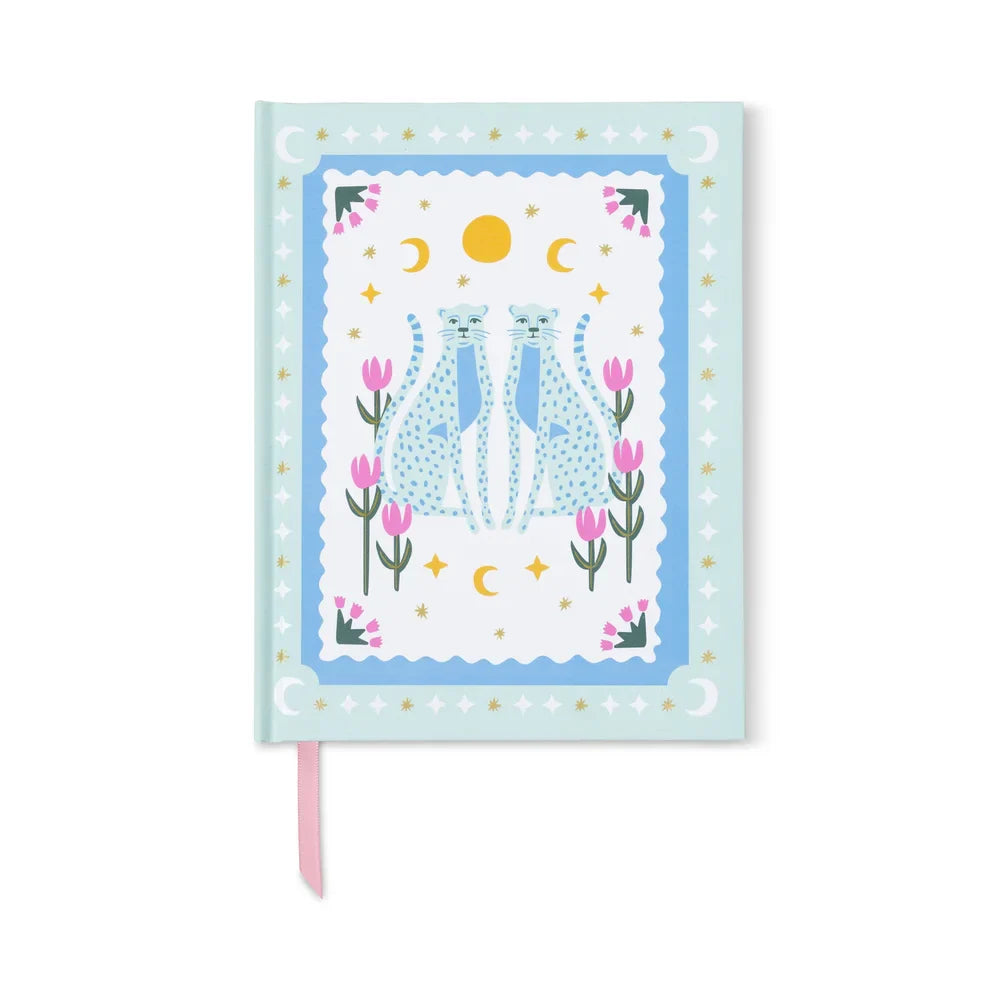 The blue cheetah journal without its band, a pink ribbon marker at the foot